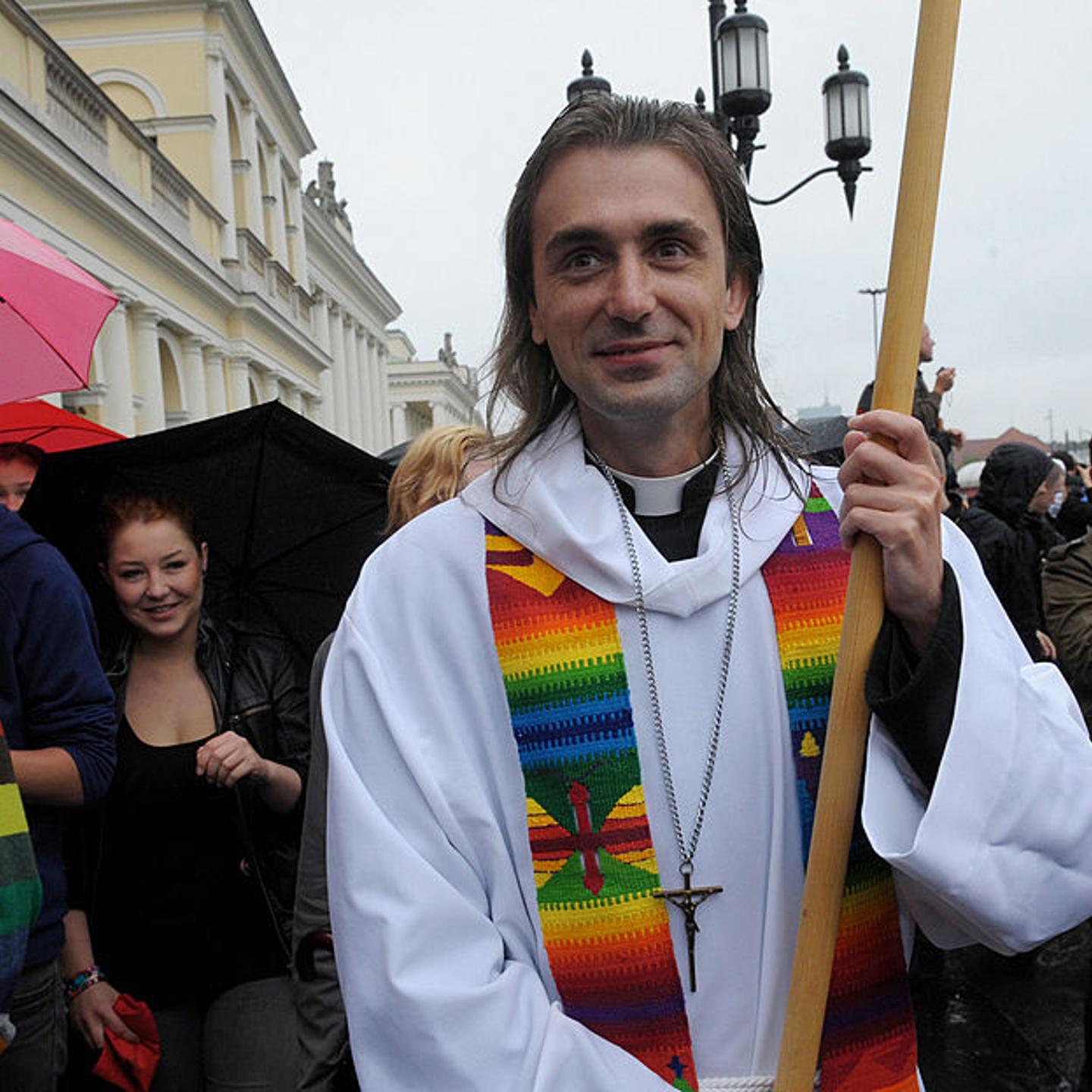 A man dressed as a priest particpates in