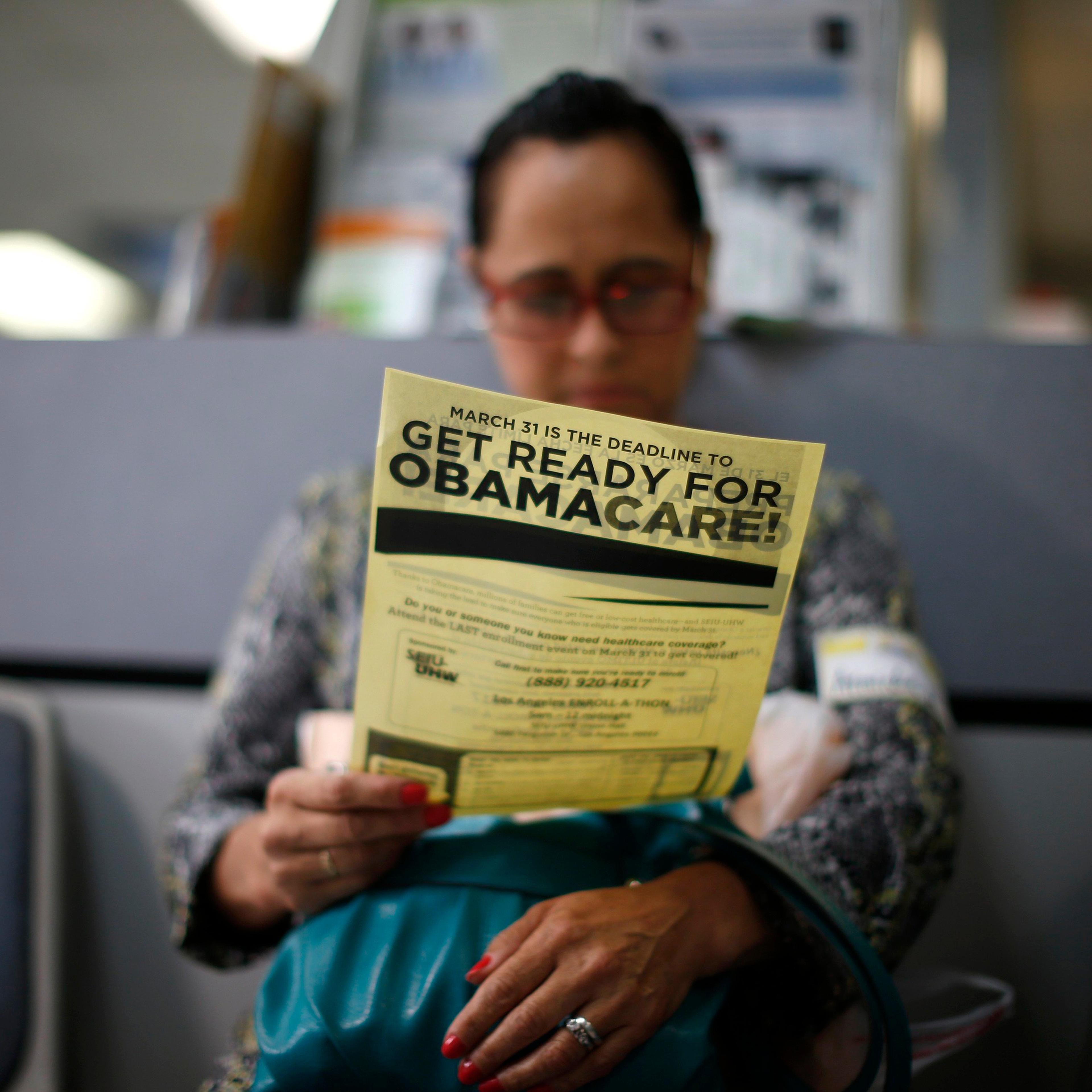 Arminda Murillo, 54, reads a leaflet at a health insurance enrollment event in Cudahy, Calif., on March 27, 2014.