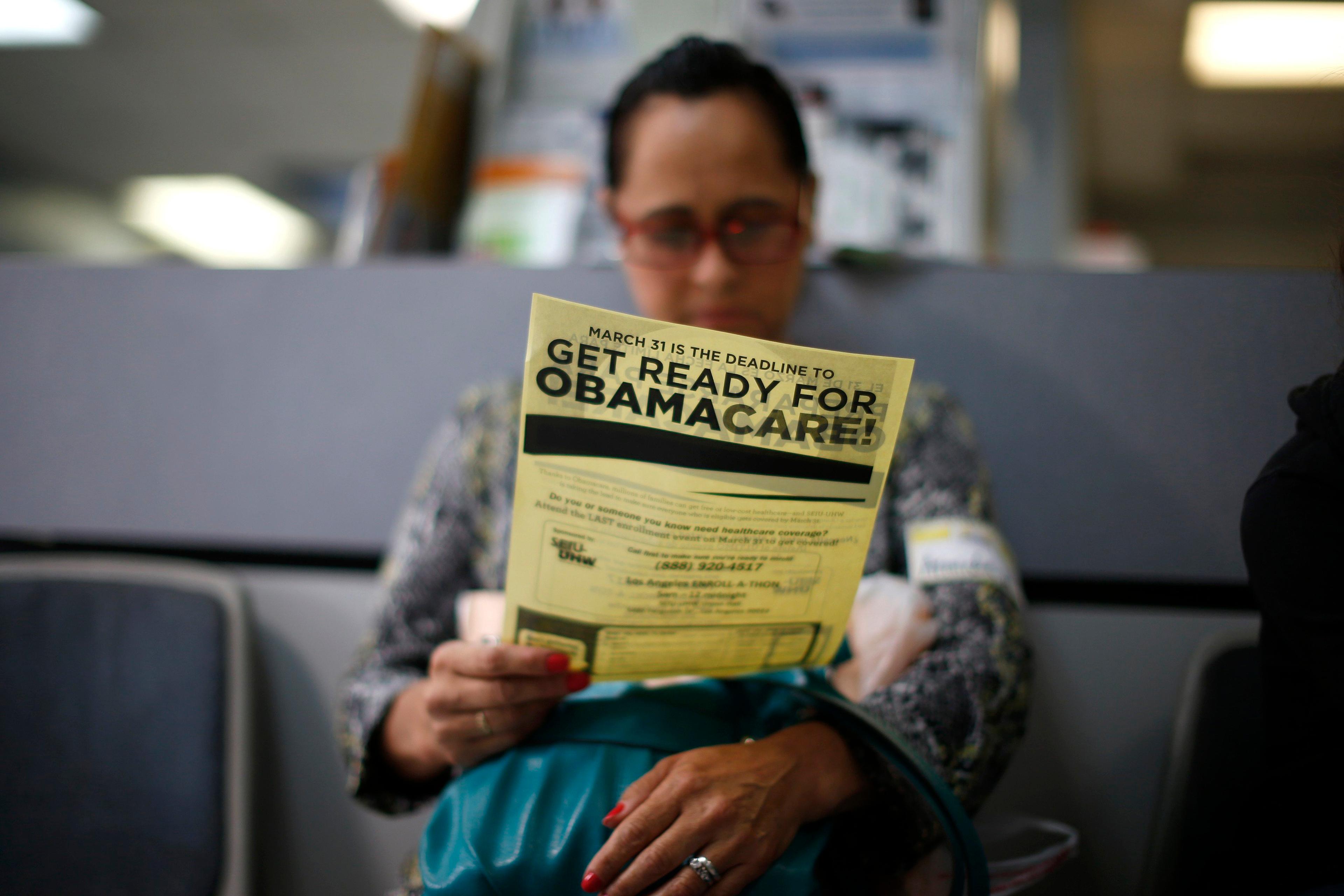 Arminda Murillo, 54, reads a leaflet at a health insurance enrollment event in Cudahy, Calif., on March 27, 2014.