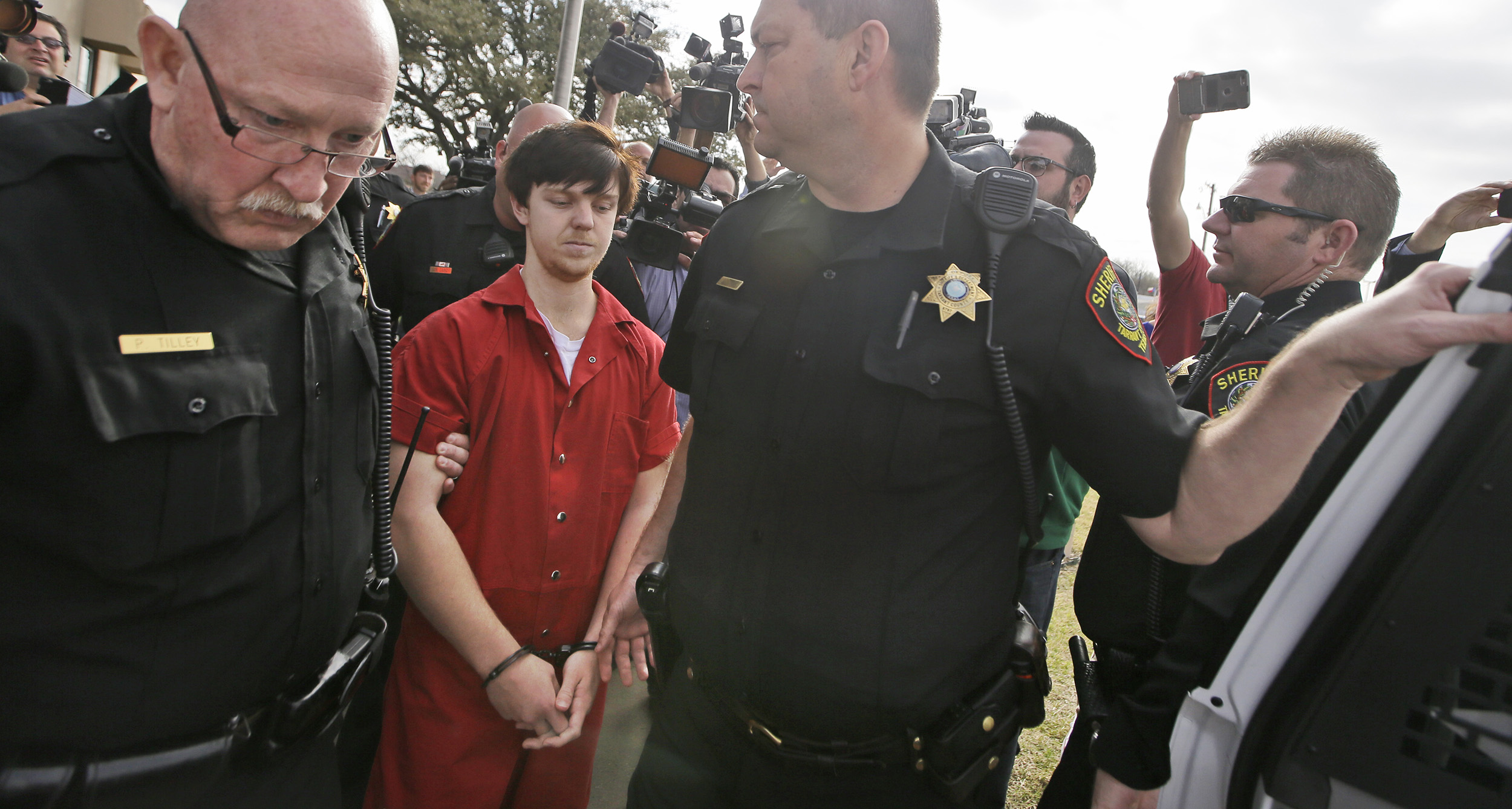 Ethan Couch is led by sheriff deputies to a waiting SUV after a juvenile court for a hearing in Fort Worth, Texas on Feb. 19, 2016.