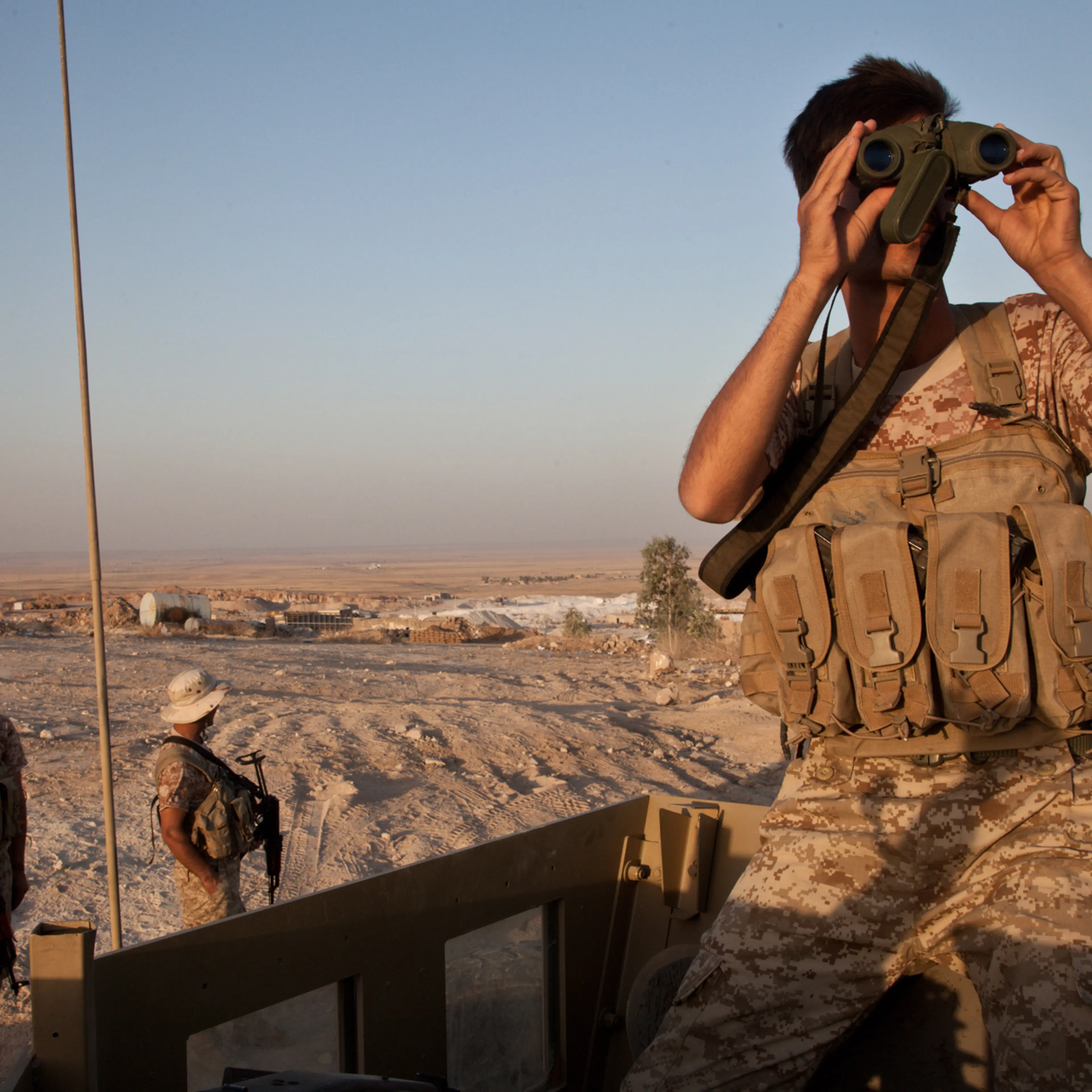 A Kurdish peshmerga soldier looks out over the town of Makhmour from defensive positions, Aug. 11, 2014.