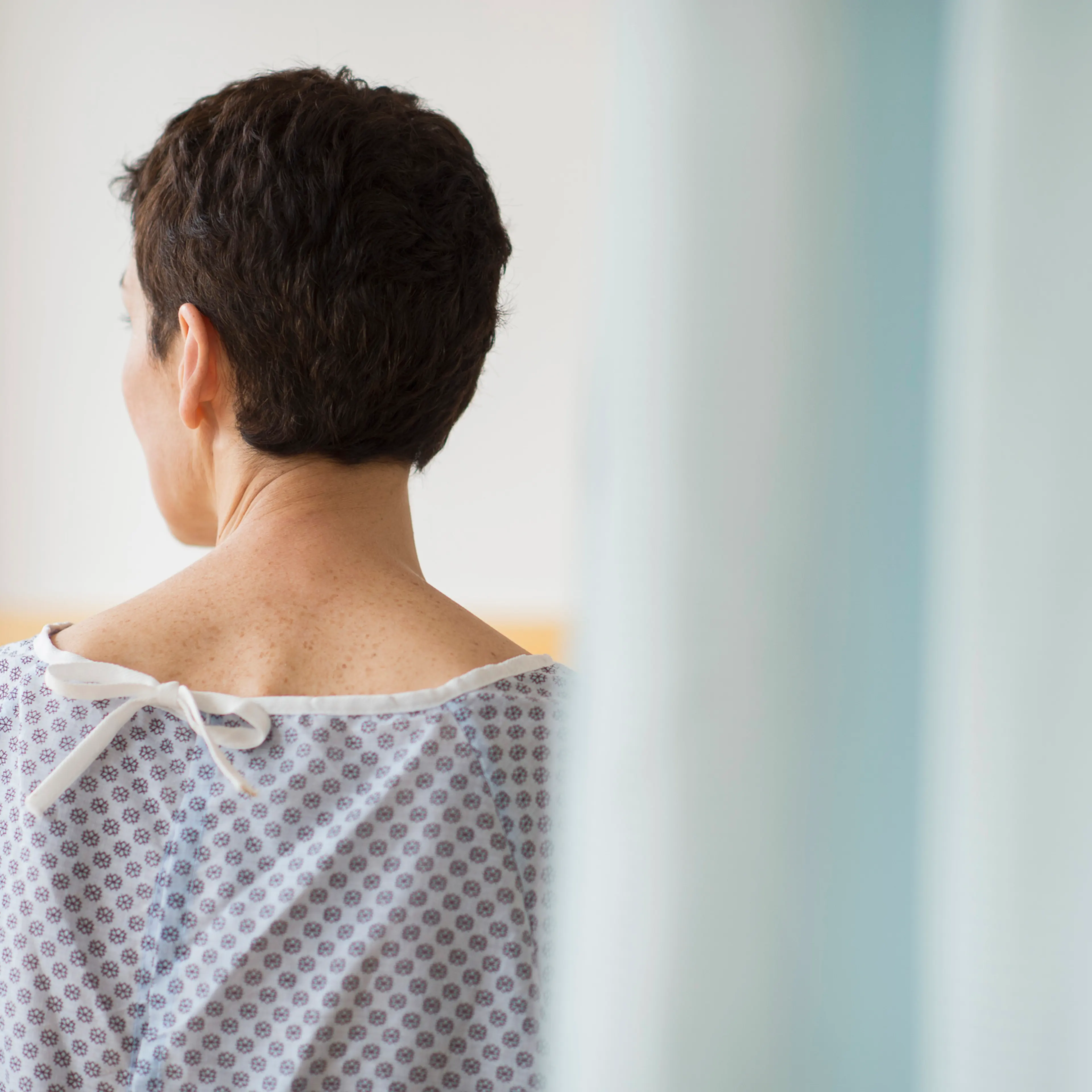 USA, New Jersey, Jersey City, Rear view of senior woman wearing hospital gown