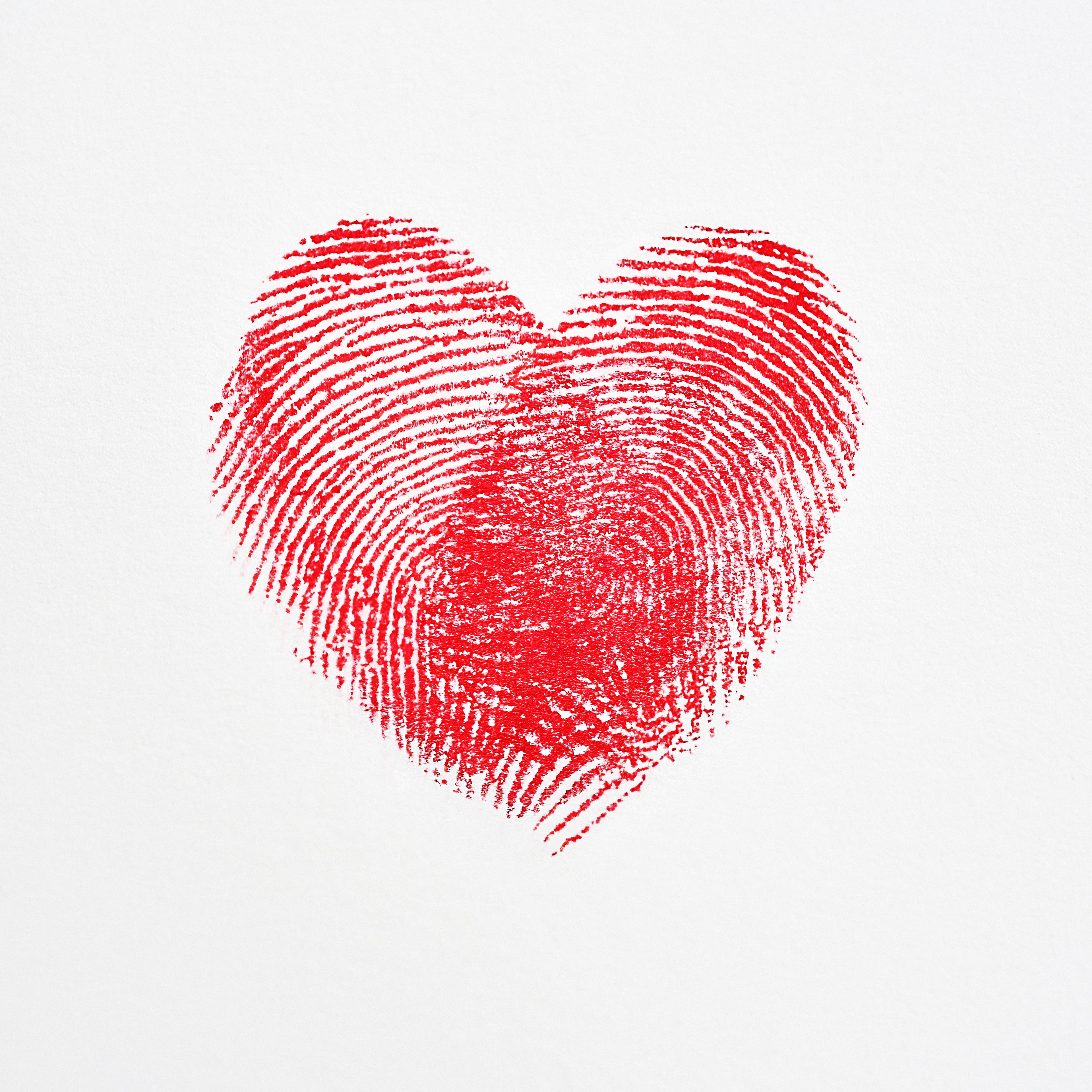 Overlapping fingerprints forming a heart shape