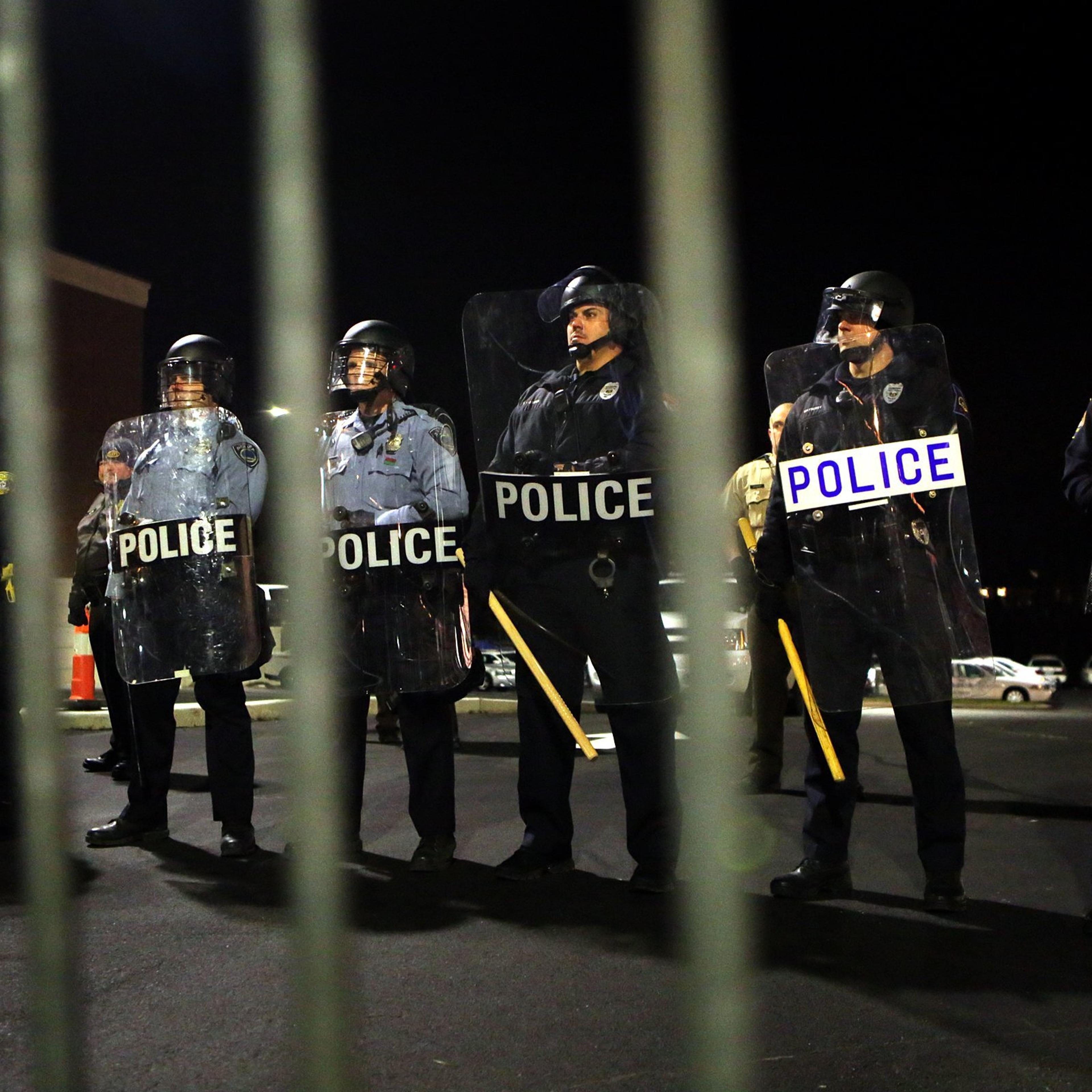 Police form a line opposite of protesters in front of the police station on Nov. 19, 2014.
