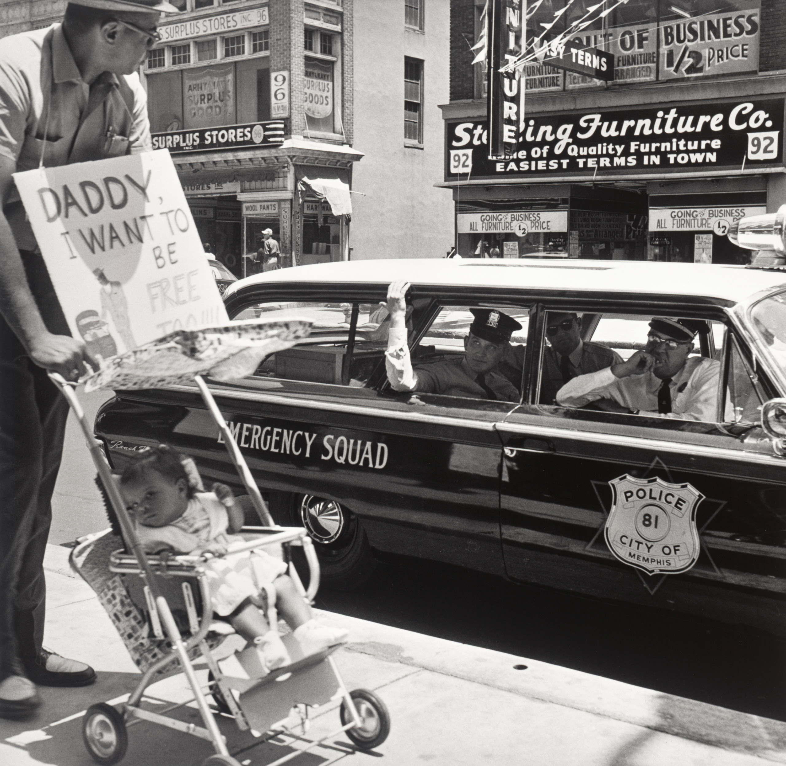 William Edwin Jones pushes daughter Renee Andrewnetta Jones (8 months old) during protest march on Main St.