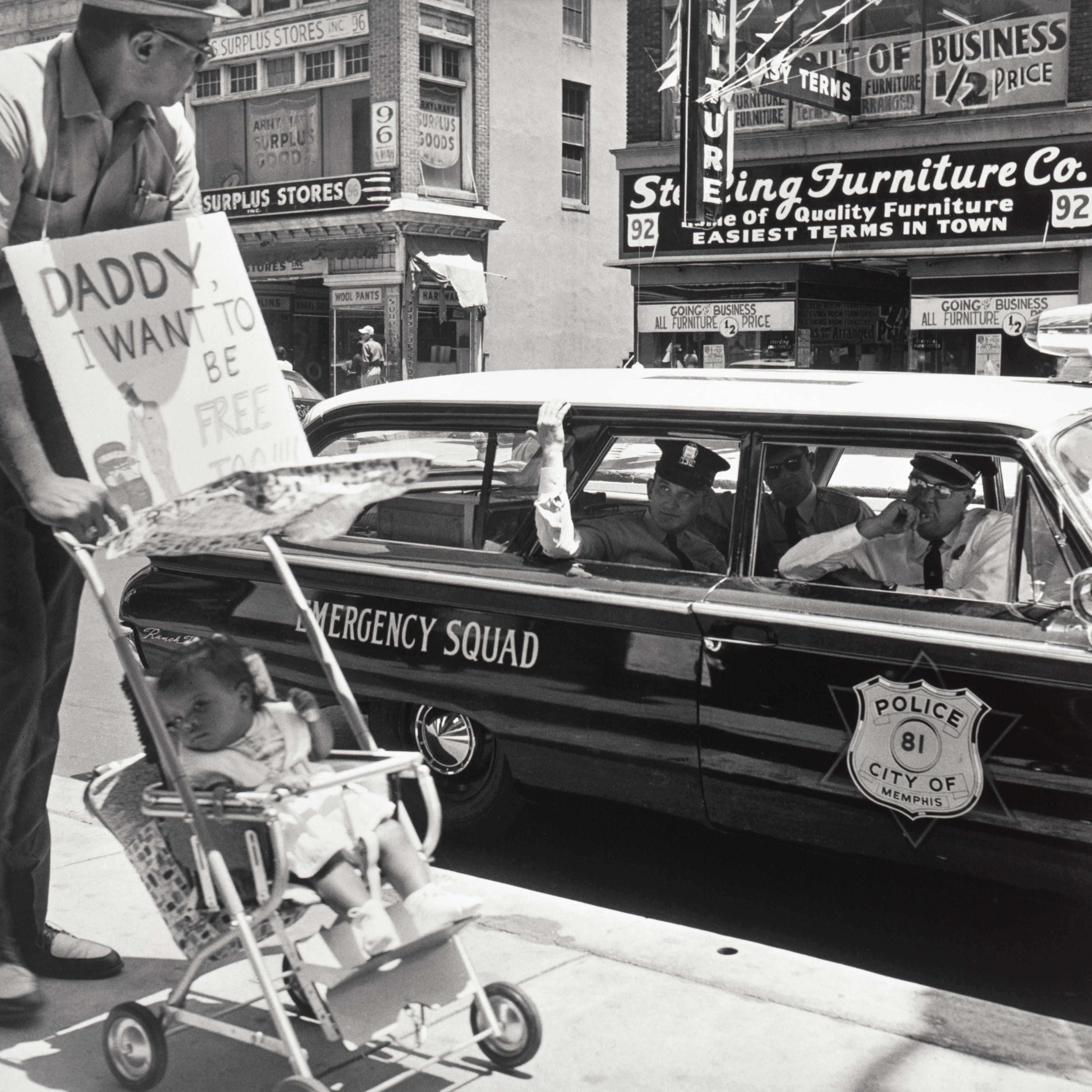 William Edwin Jones pushes daughter Renee Andrewnetta Jones (8 months old) during protest march on Main St.