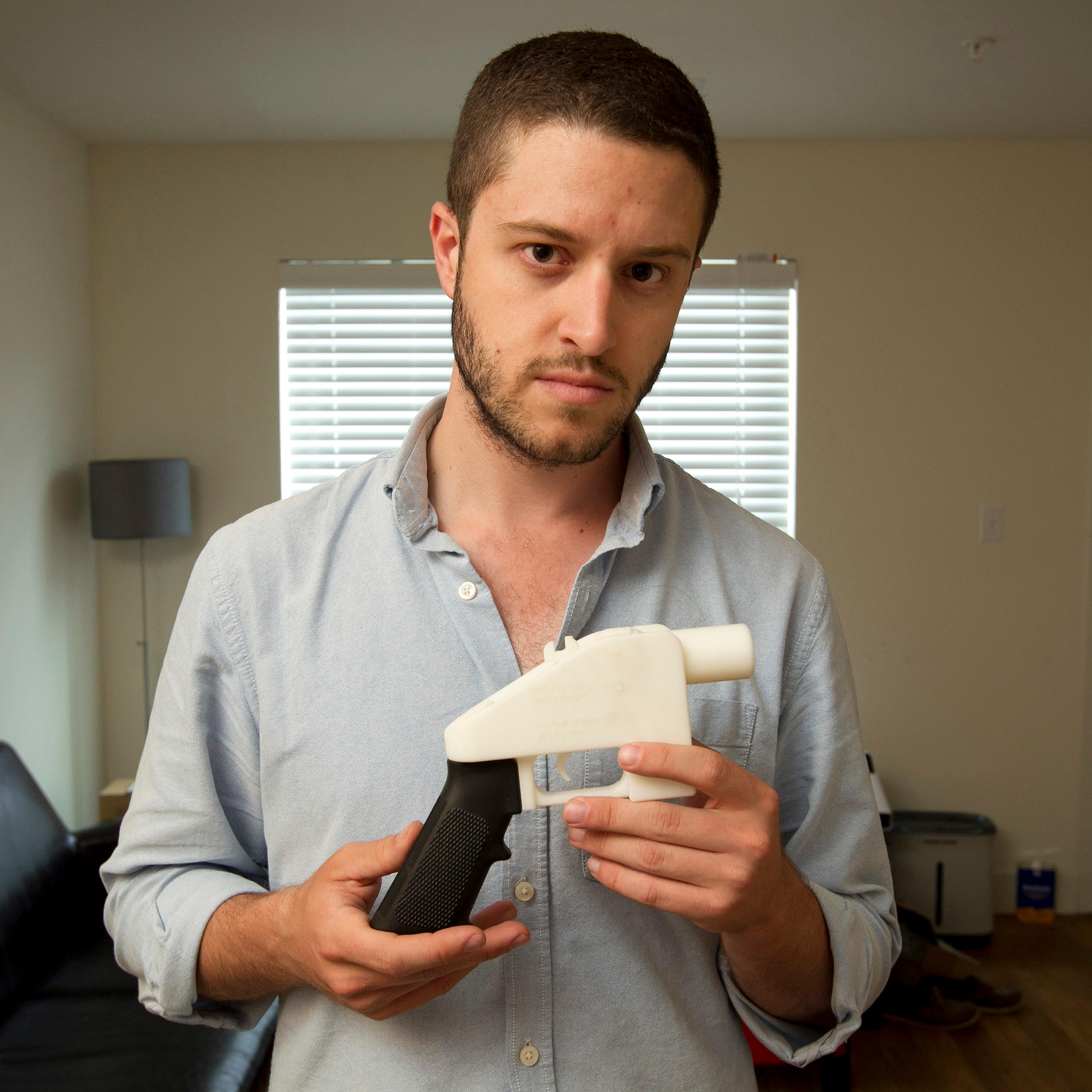 In this May 10, 2013 photo, Cody Wilson, the founder of Defense Distributed, shows a plastic handgun made on a 3D-printer at his home in Austin, Texas.