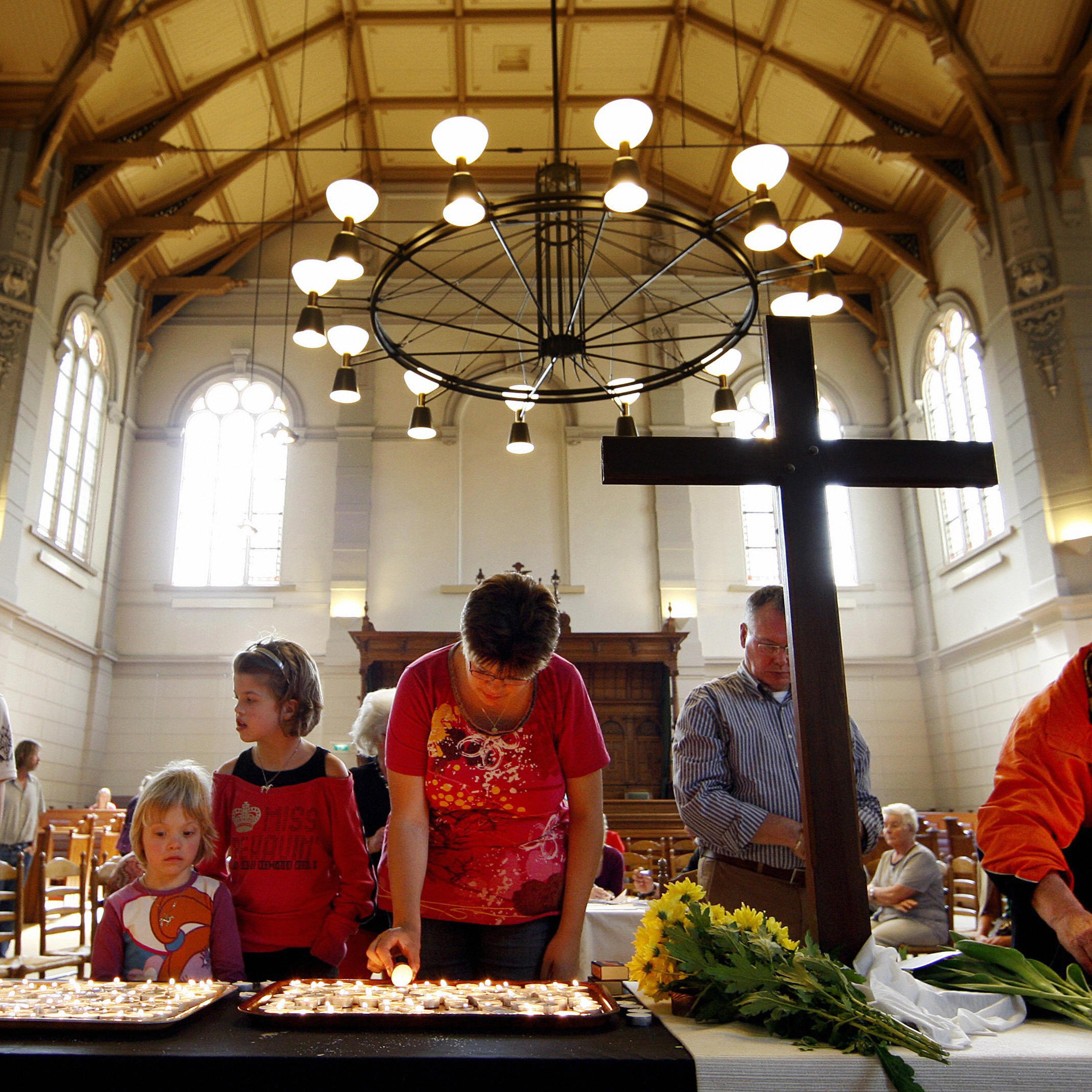 People burn candles at a church at for t