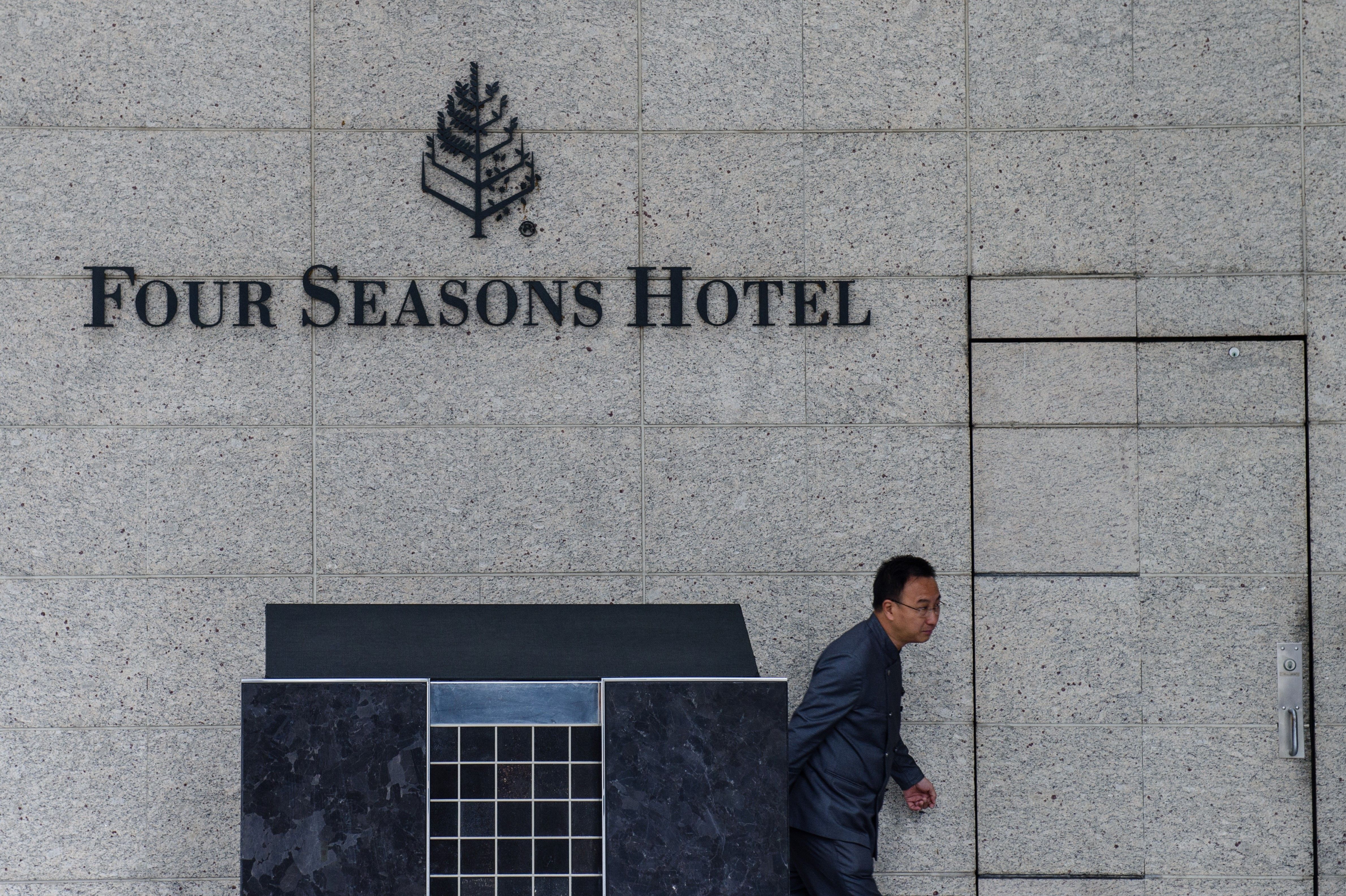 A member of staff walks outside the Four Seasons Hotel in Hong Kong on February 1, 2017. A Chinese billionaire has been abducted in Hong Kong by mainland agents, according to reports on January 31, triggering more concerns over security in the city after