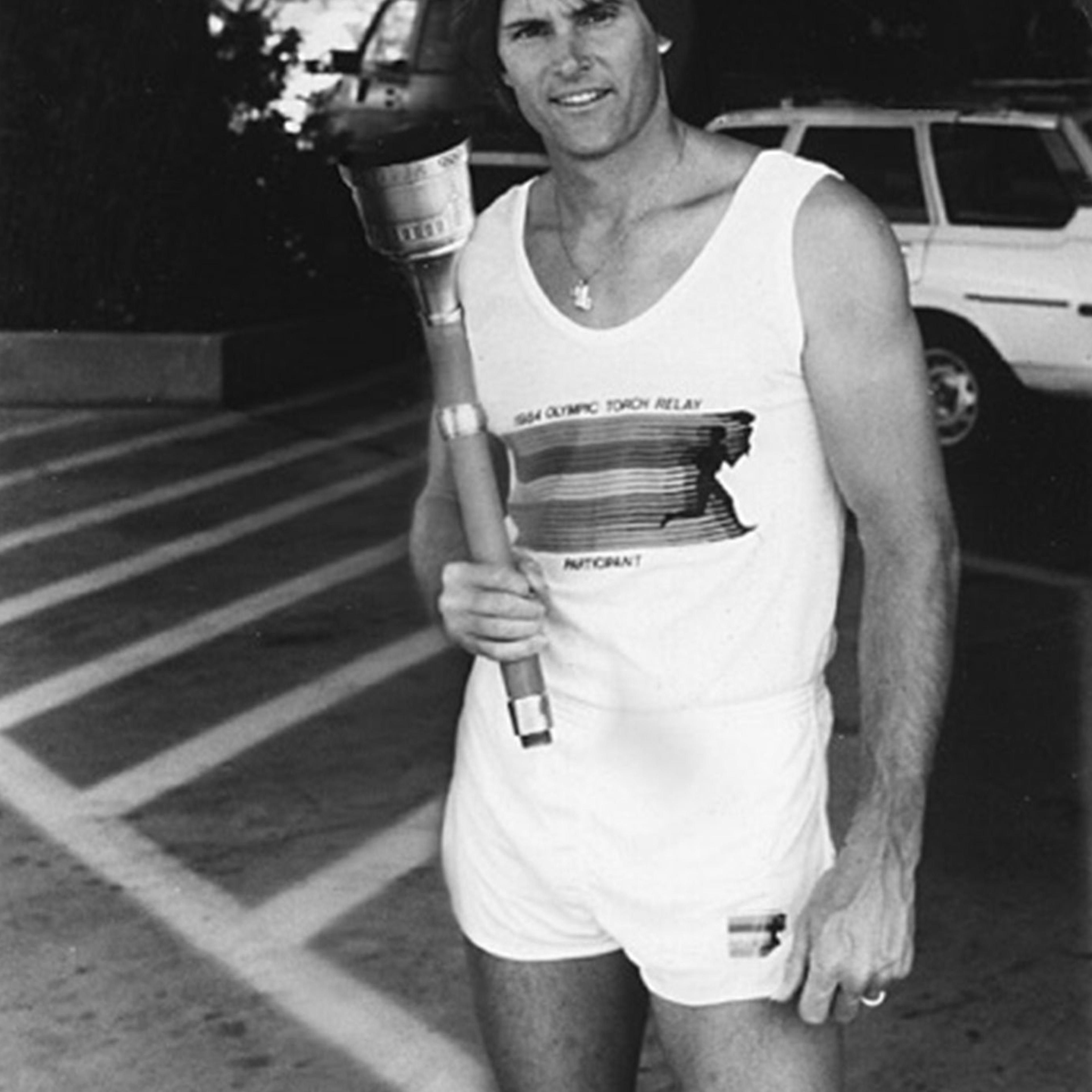 American Decathlete, Bruce Jenner poses with the 1984 Olympic Torch he carried through Lake Tahoe, Nevada.