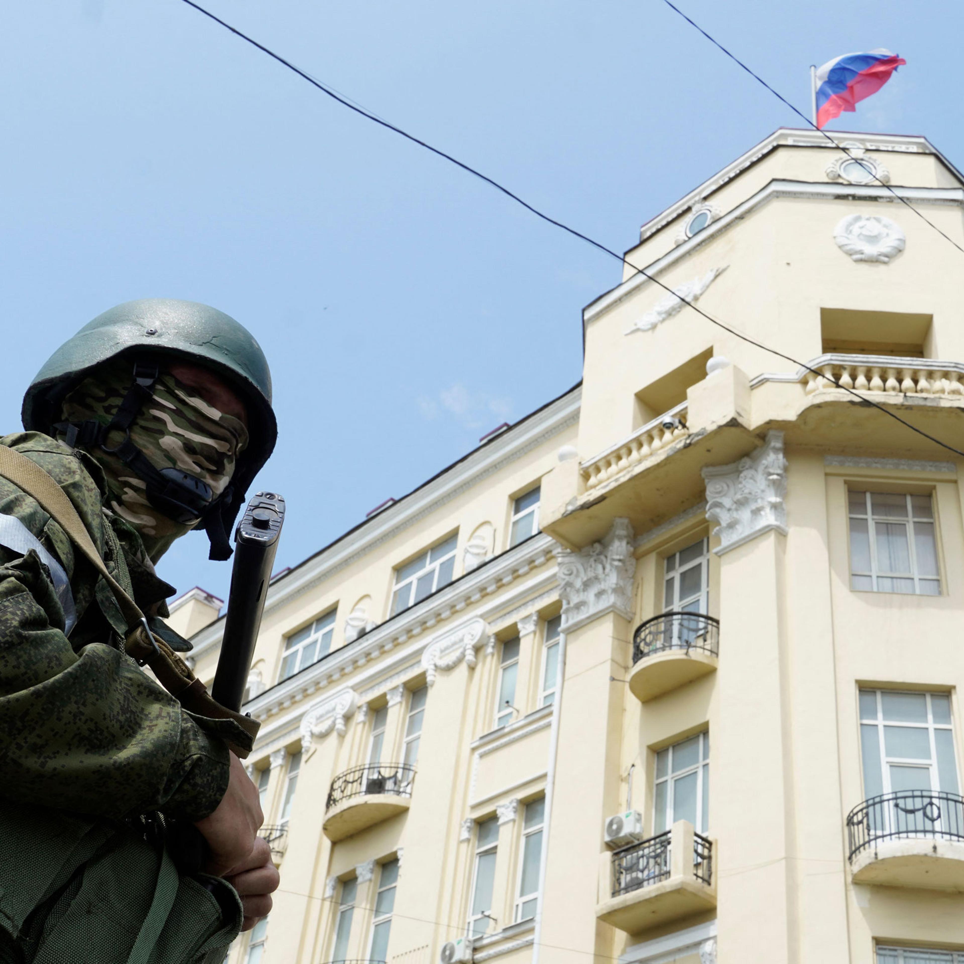 A member of the Wagner group stands guard outside the headquarters of the Russian Southern Military District in the city of Rostov-on-Don