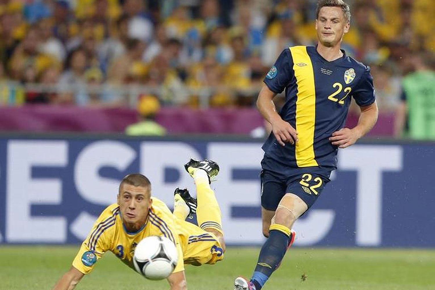 Sweden's Markus Rosenberg (R) challenges Ukraine's Yevhen Khacheridi during a soccer match at Olympic Stadium in Kiev in June 2012