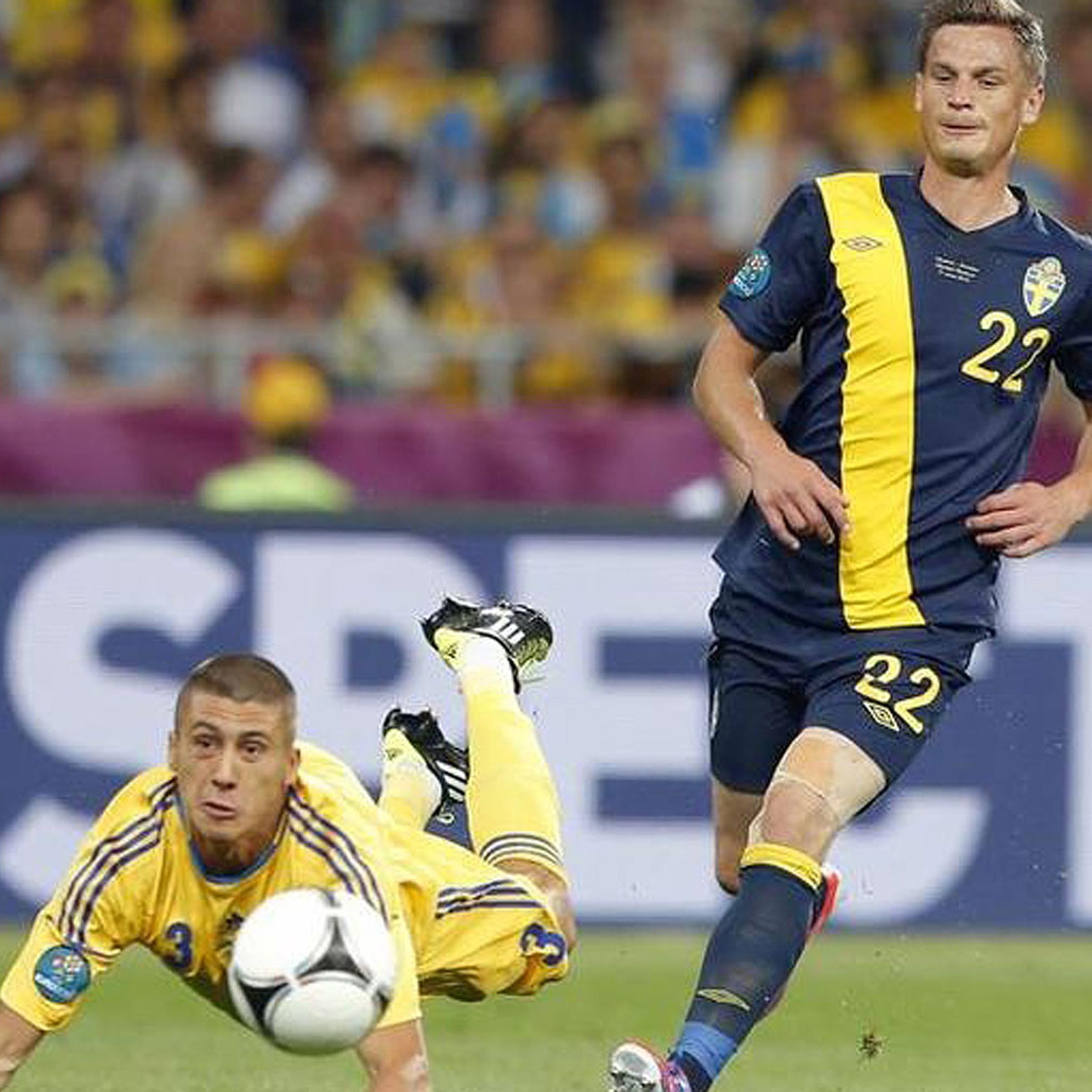 Sweden's Markus Rosenberg (R) challenges Ukraine's Yevhen Khacheridi during a soccer match at Olympic Stadium in Kiev in June 2012