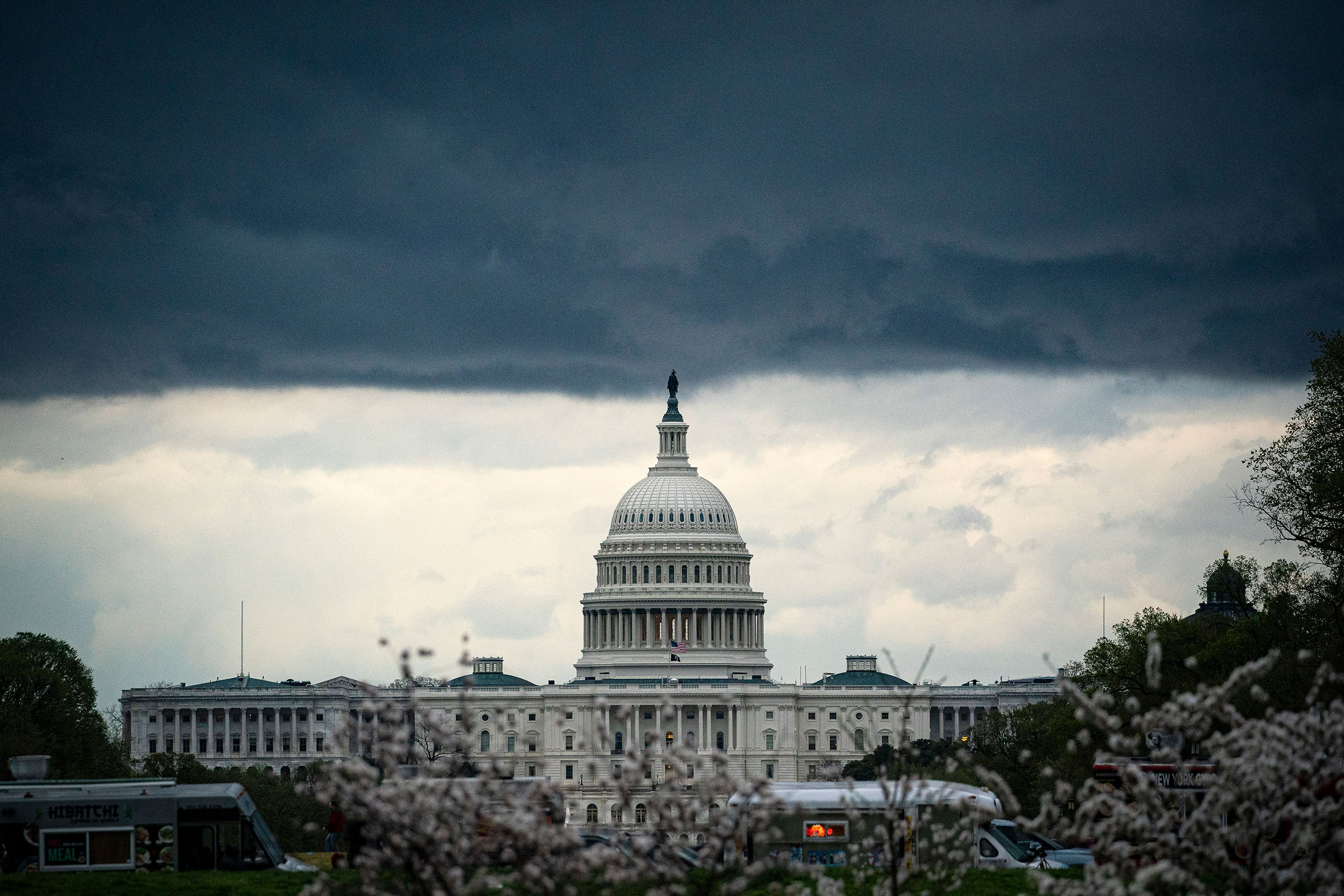 Clouds form above the U.S. Capitol in between rain showers on the National Mall on March 28, 2021.