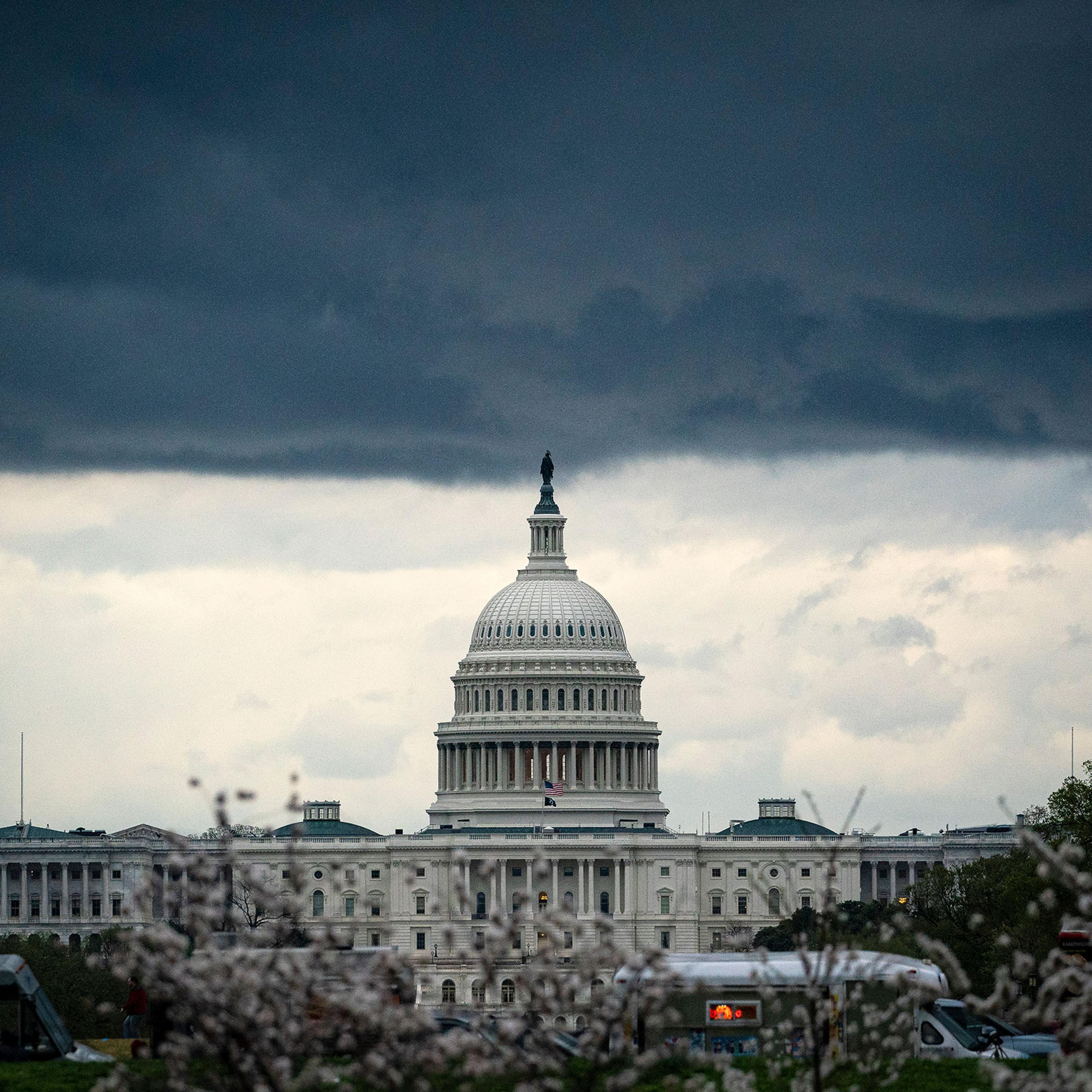 Clouds form above the U.S. Capitol in between rain showers on the National Mall on March 28, 2021.