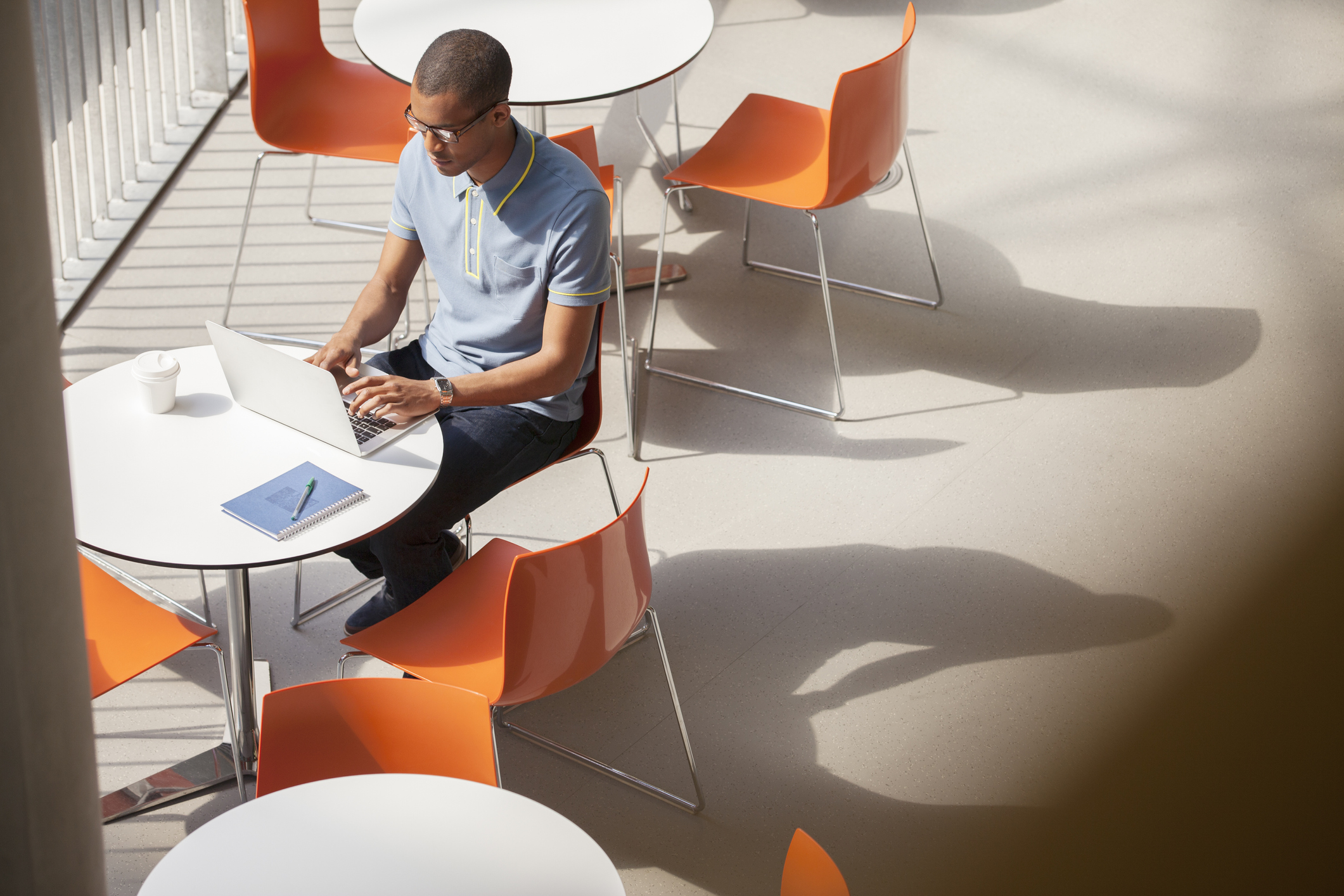 Businessman working on laptop in cafe