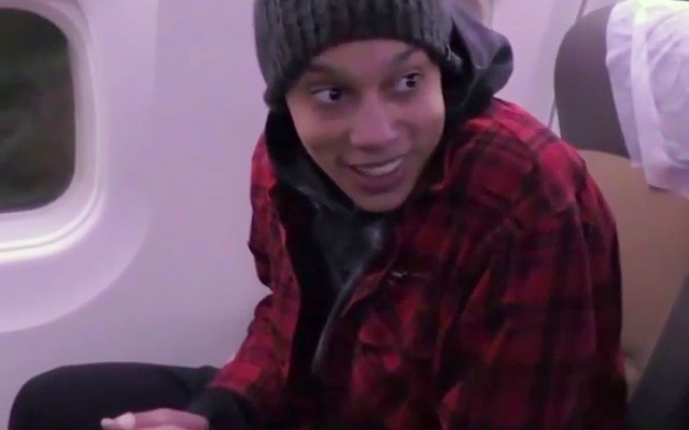 In this image made from video provided by Russian Federal Security Service, WNBA star and two-time Olympic gold medalist Brittney Griner sits in the plane as she flies to Abu Dhabi to be exchanged for Russian citizen Viktor Bout, in Russia, Friday, Dec. 
