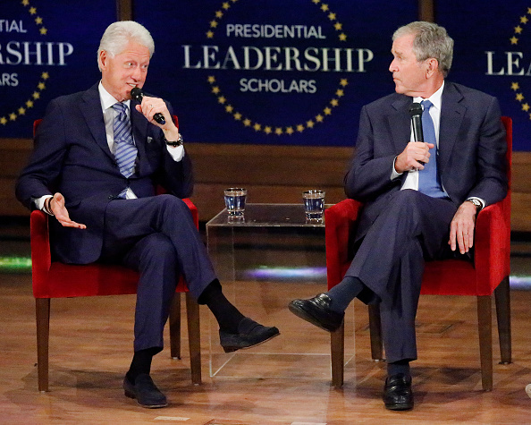 Former U.S. President George W. Bush (R) looks on as former president Bill Clinton answers a question at the Presidential Leadership Scholars graduation ceremony at the George W. Bush Institute on July 13, 2017 in Dallas, Texas.