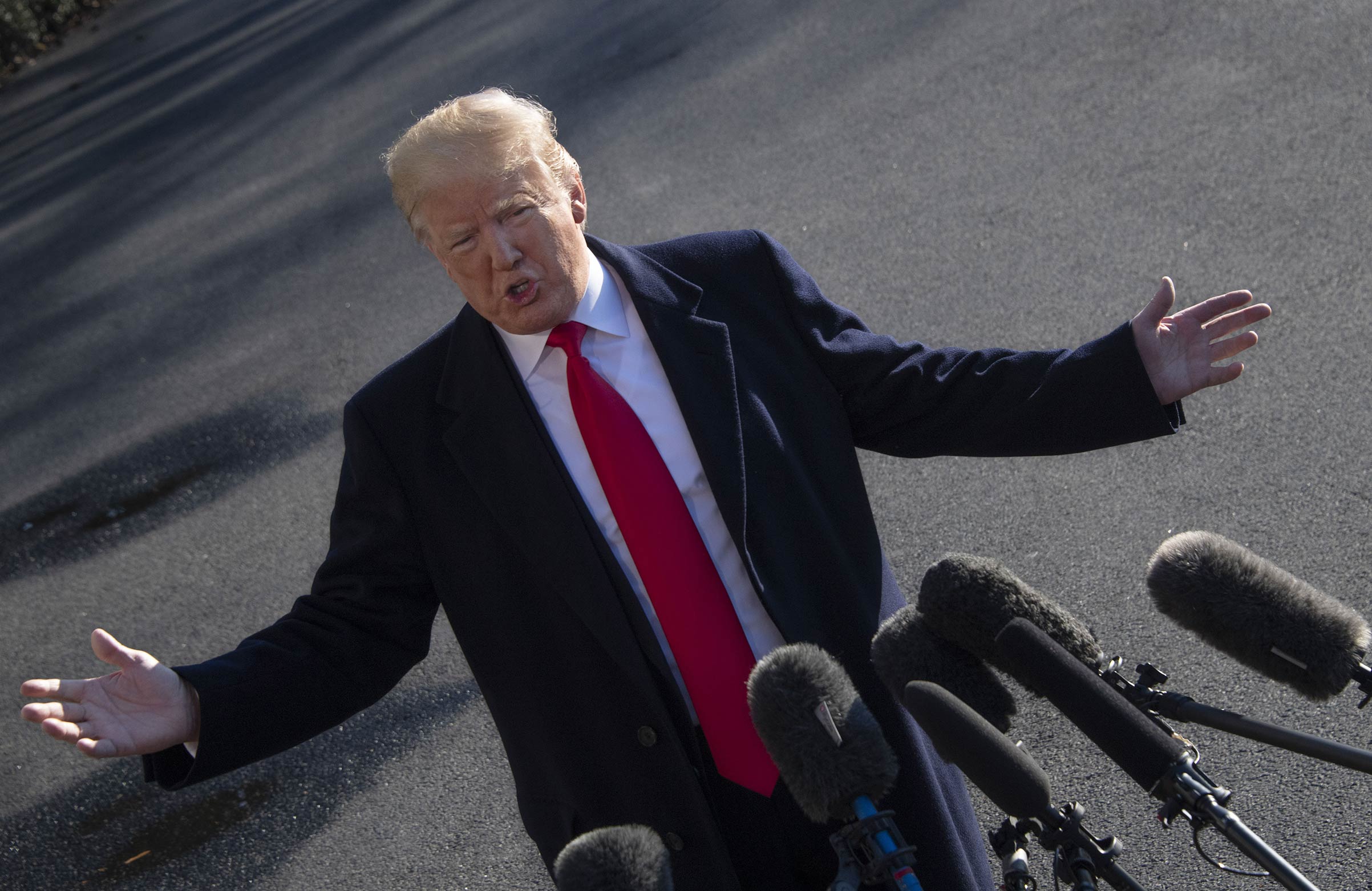 President Trump reiterates threat to declare a national emergency to build a wall on the U.S.-Mexico border to reporters as he departs the White House on January 6, 2019, for meetings at Camp David, the presidential retreat in Maryland.