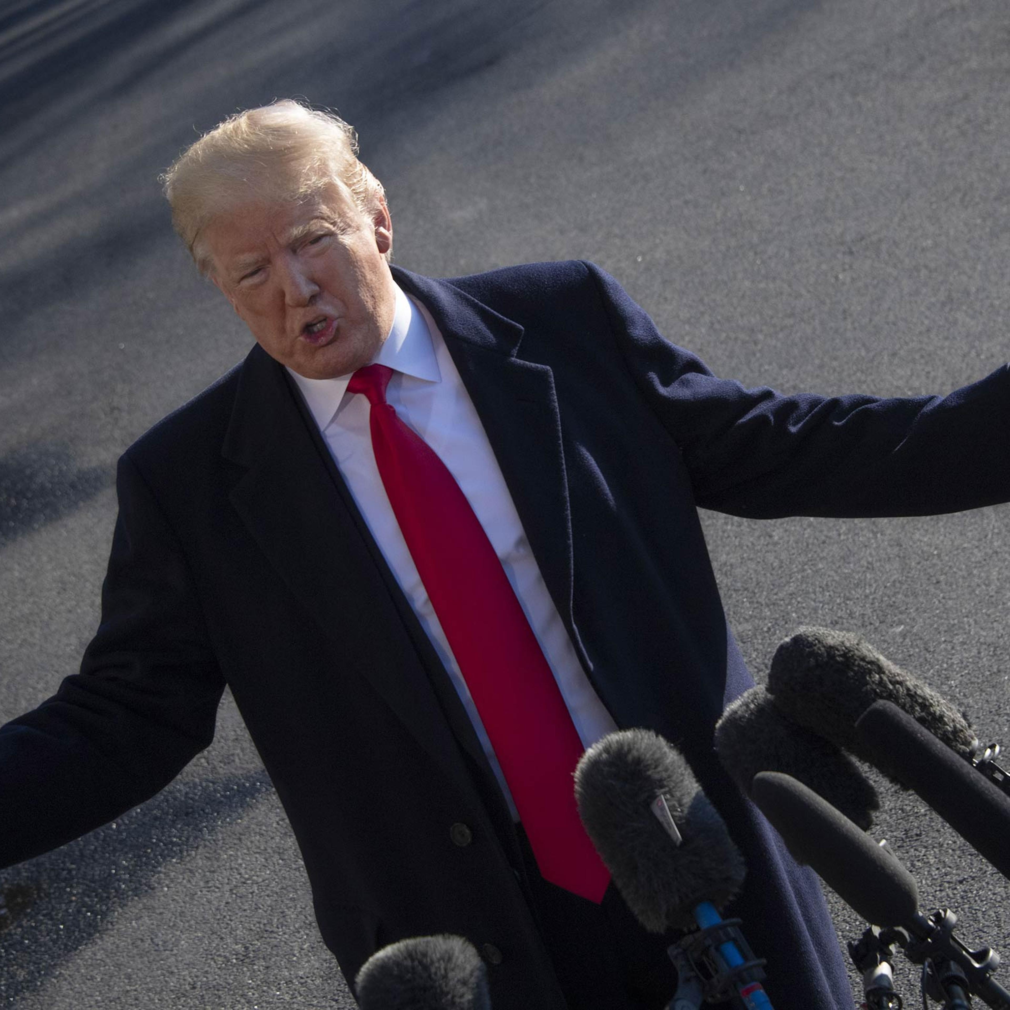 President Trump reiterates threat to declare a national emergency to build a wall on the U.S.-Mexico border to reporters as he departs the White House on January 6, 2019, for meetings at Camp David, the presidential retreat in Maryland.