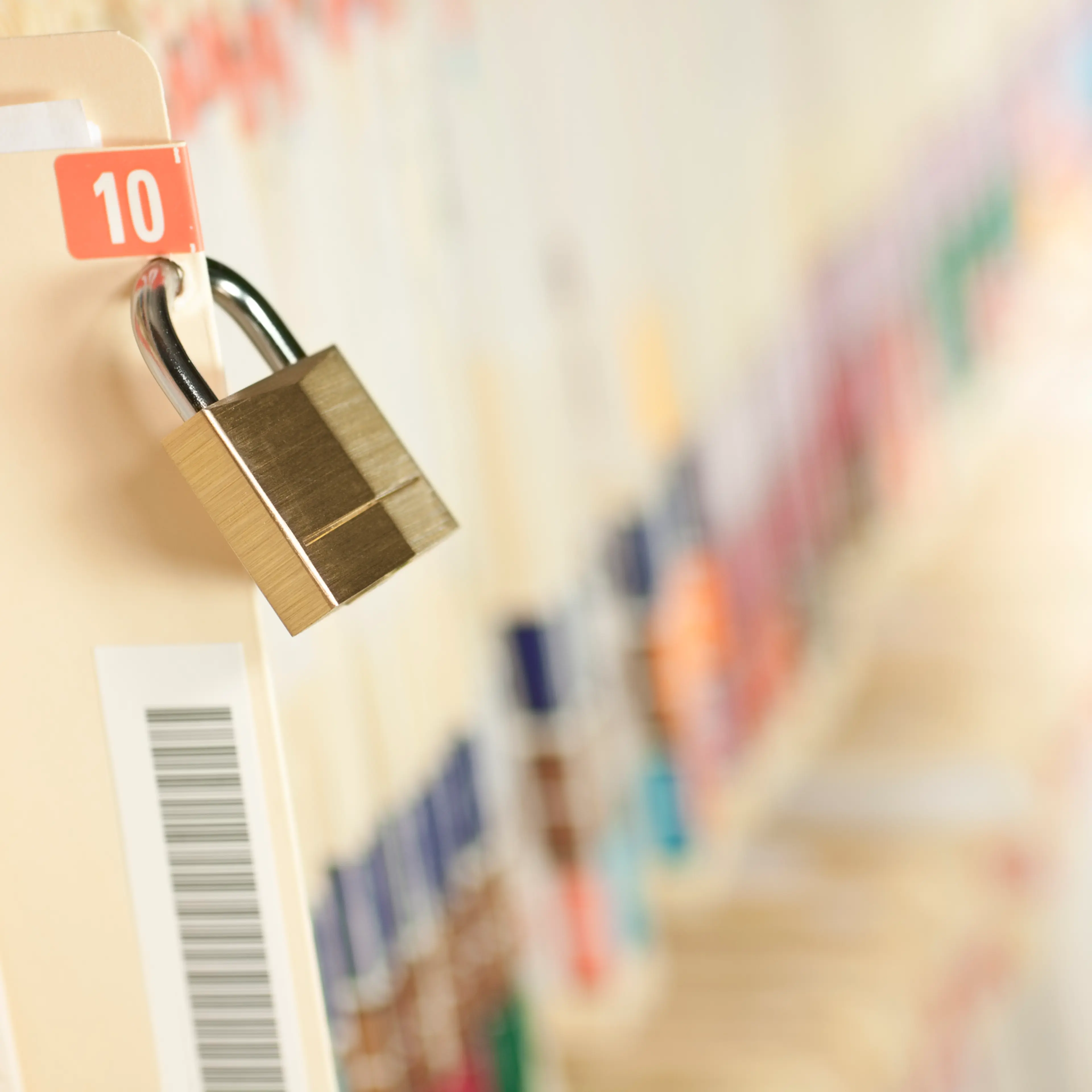 A row of medical records with a lock on one of the files.