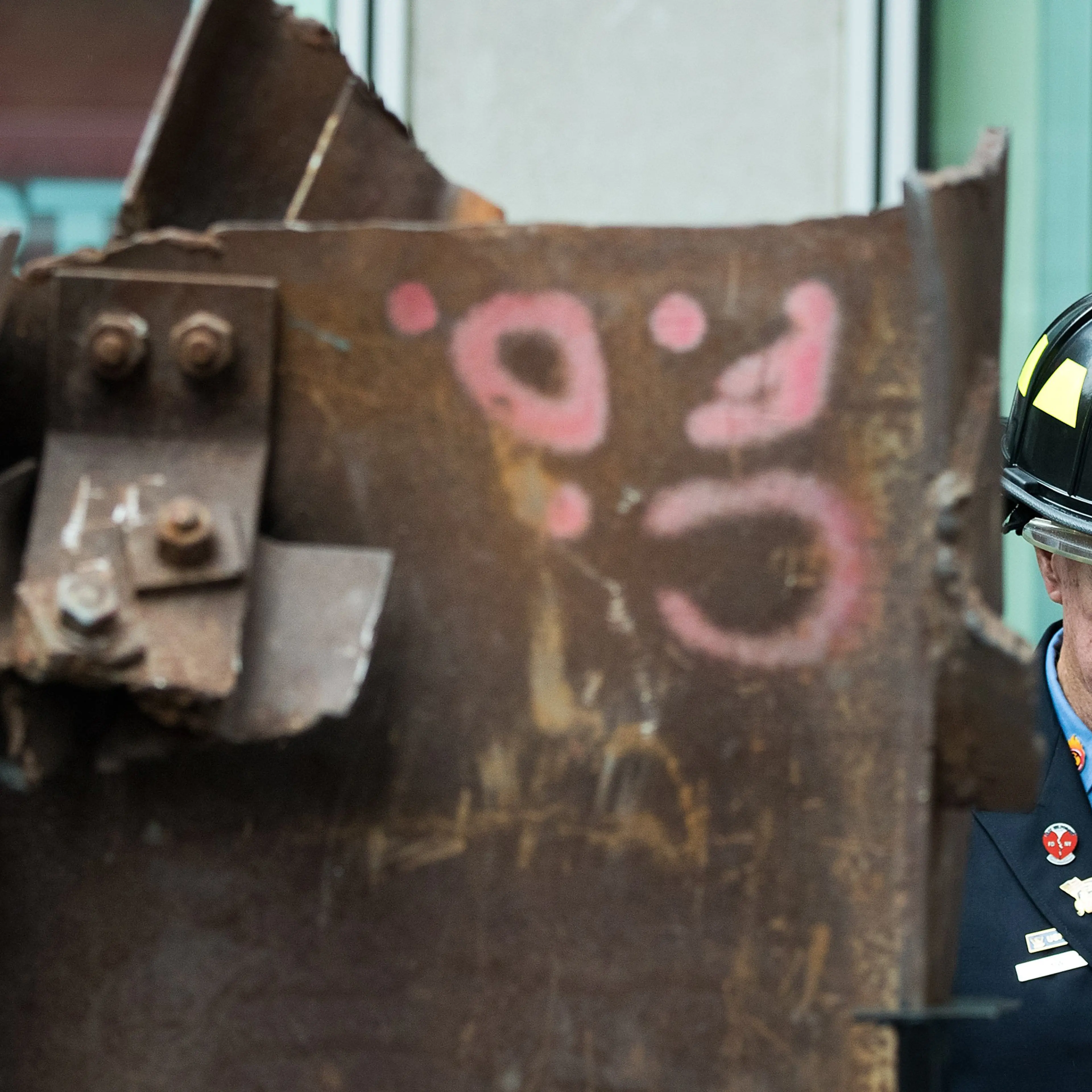Bob Beckwith, retired firefighter who stood next to President George W. Bush at ground zero, stands next to a piece of steel from the World Trade Center, during a ceremony outside the Fox News studios to mark the beginning of the piece of steel's journey