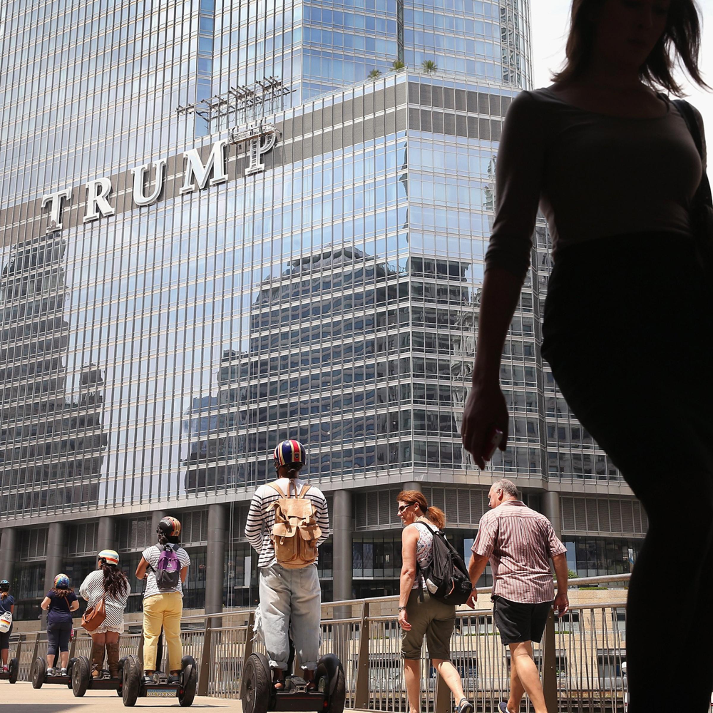 Workers install the final letter for a giant TRUMP sign on the outside of the Trump Tower on June 12, 2014 in Chicago, Ill.