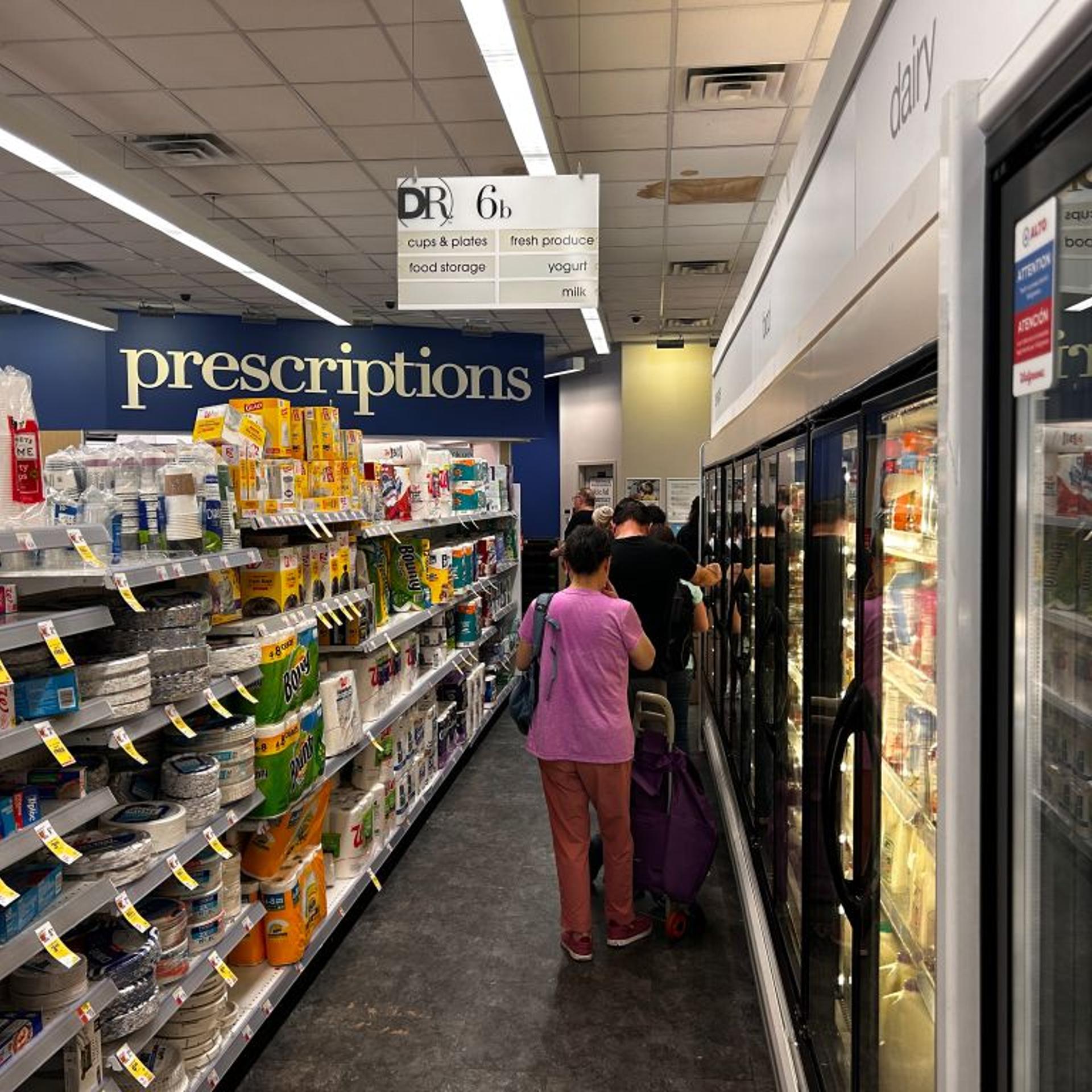 Long line of customers waiting to pick up Prescriptions at Walgreens pharmacy, Queens, New York