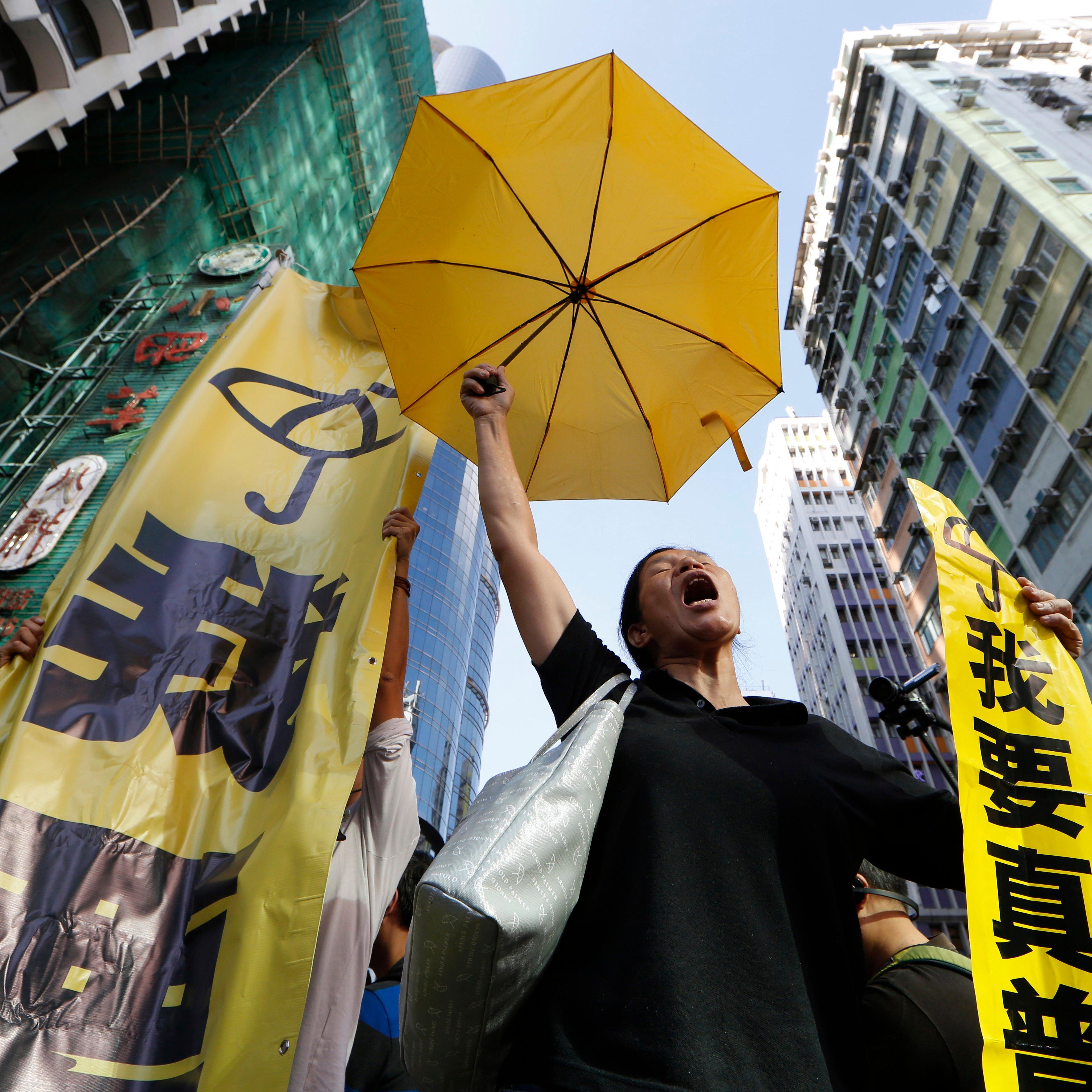 A pro-democracy protester chants at an occupied area before the barricade is removed in Mong Kok district of Hong Kong on Nov. 25, 2014.