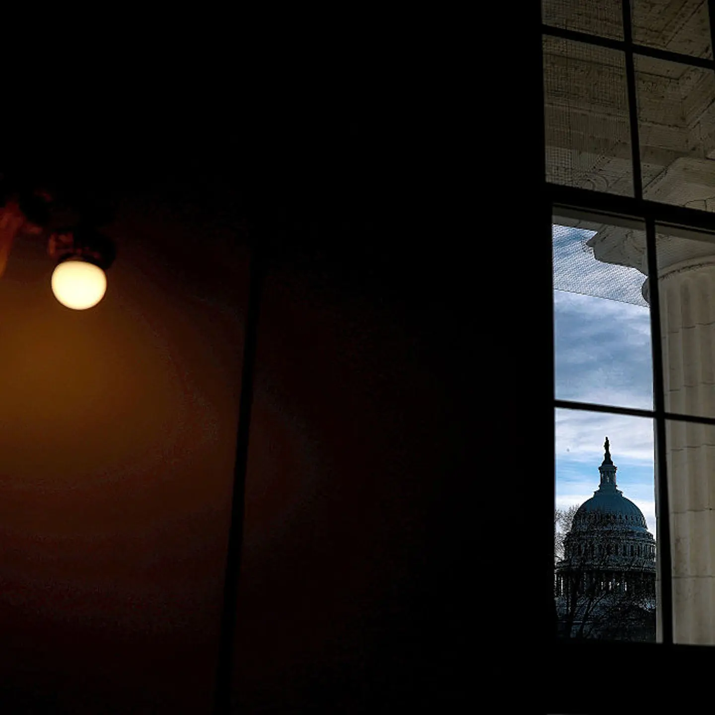 The U.S. Capitol Building is seen through a window in the Russell Senate Office Building as the Senate continues negotiations on a government funding bill in Washington, D.C. on Jan. 29, 2026.