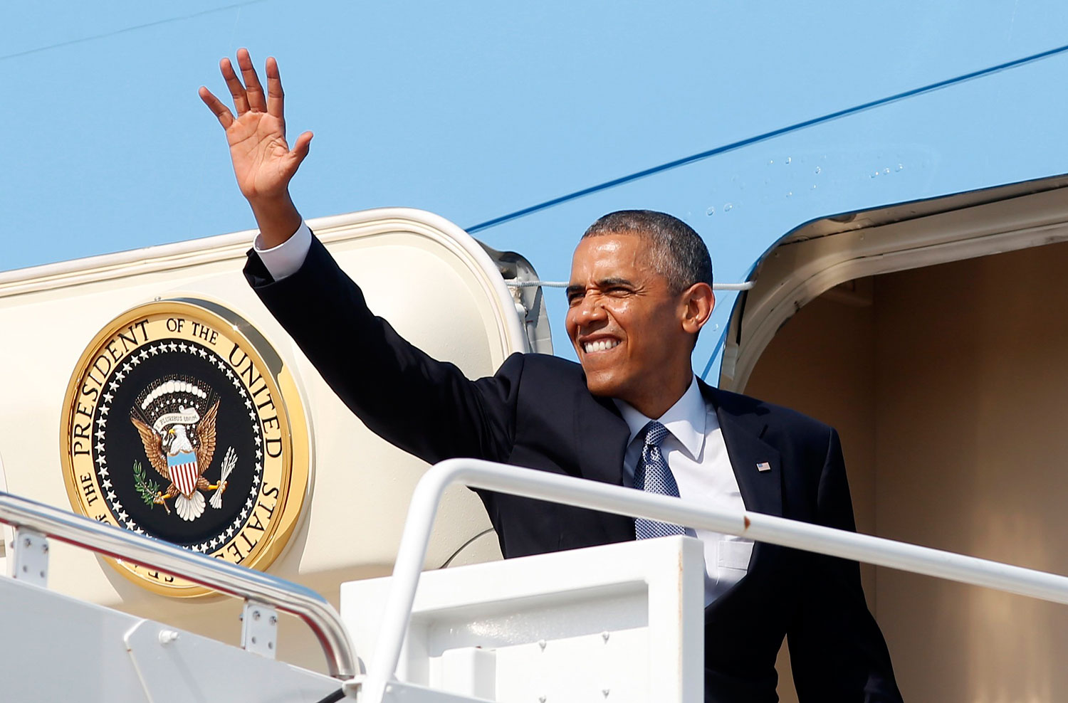 Obama waves from Air Force One as he departs Joint Base Andrews in Washington en route to Denver