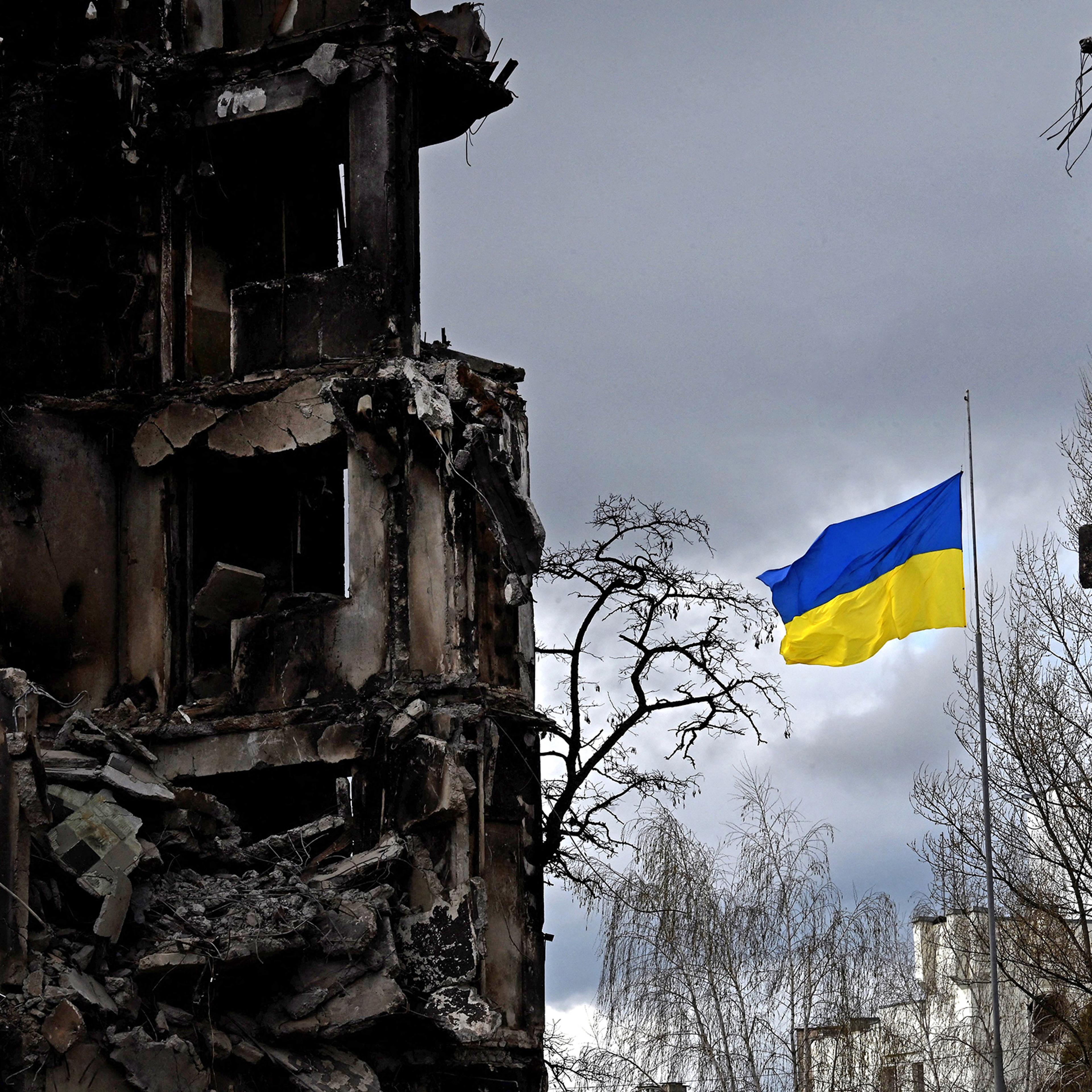 The Ukrainian flag flutters between buildings destroyed in bombardment, in the Ukrainian town of Borodianka, in the Kyiv region on April 17, 2022.