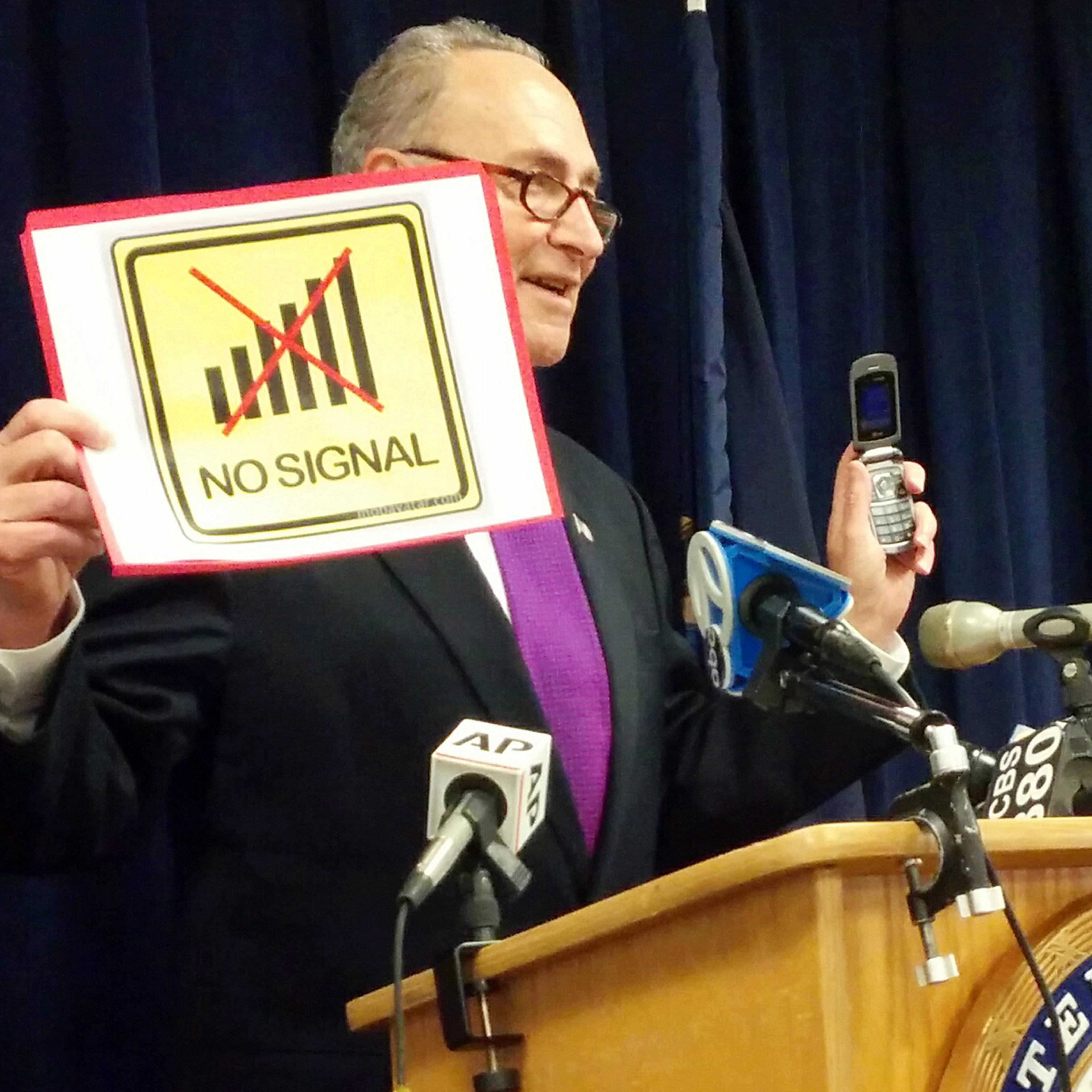 With a flip phone in one hand and a "no signal" sign in the other, Sen. Charles Schumer speaks in New York on Jan. 17, 2016, about improving New Yorkers' cellphone service—by tracking dead zones where calls are regularly dropped.