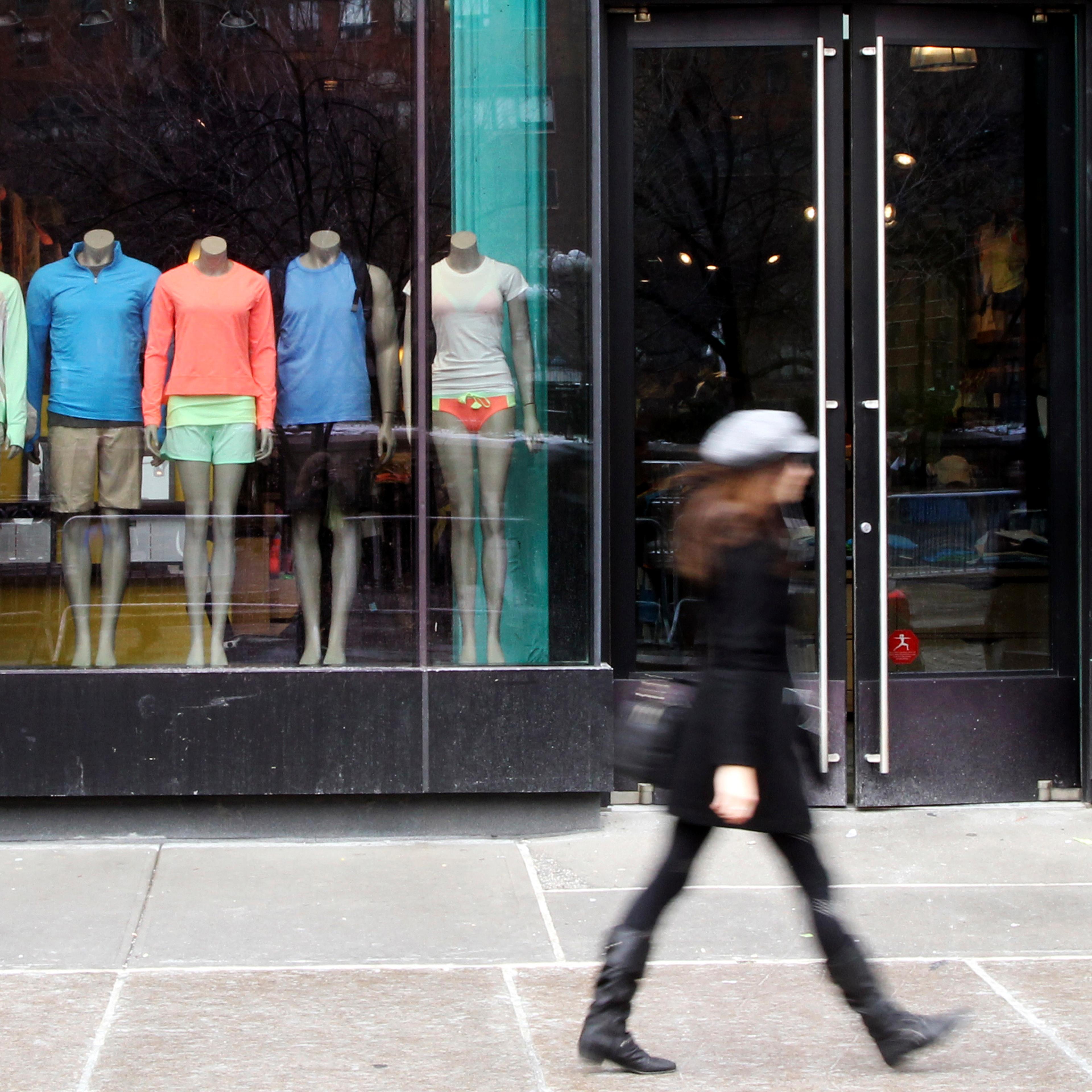 A pedestrian walks past the Lululemon Athletica store at Union Square in New York, March 19, 2013.