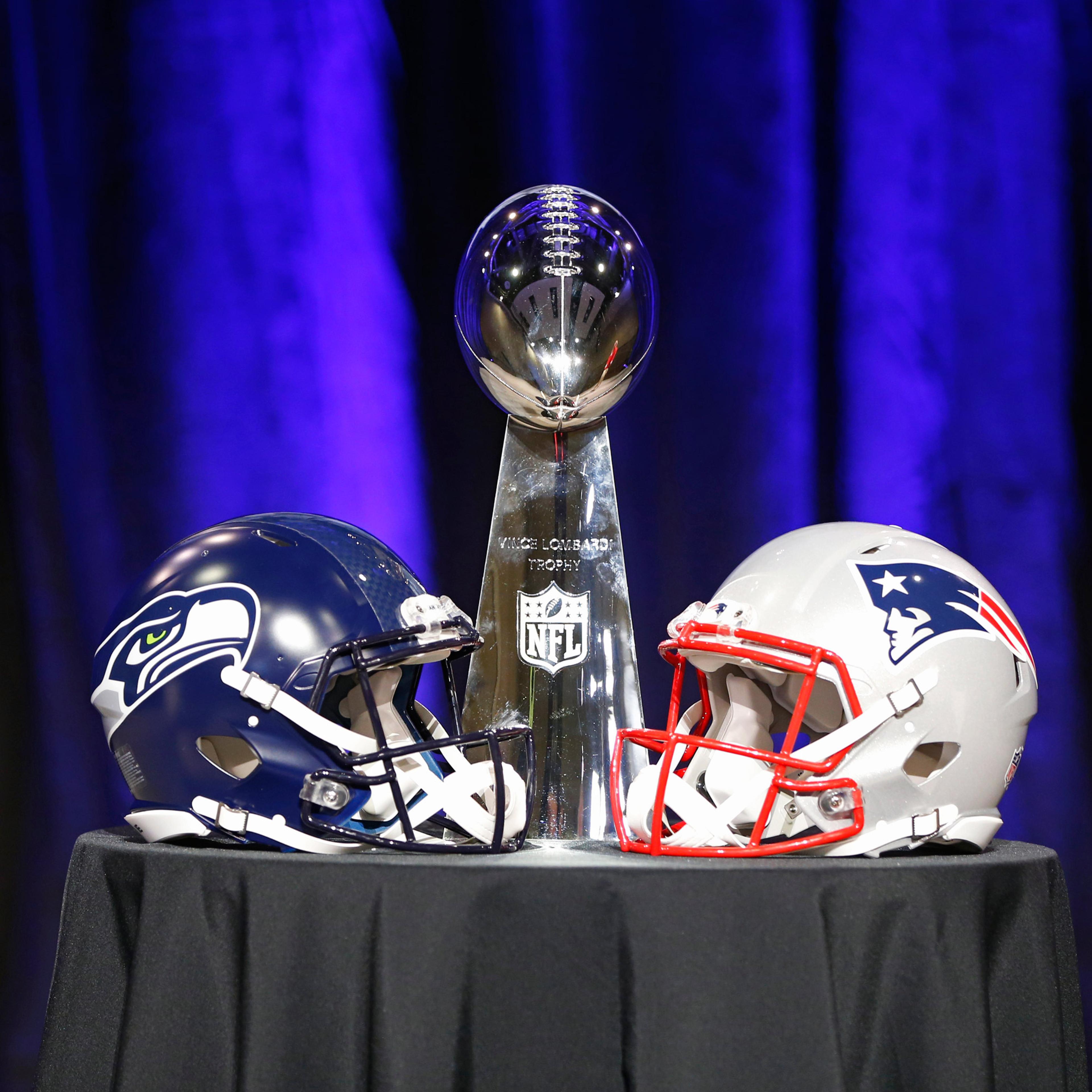 General view of the Super Bowl XLIX trophy with a helmet from both the Seattle Seahawks and the New England Patriots during a press conference for Super Bowl XLIX on Friday, Jan. 30, 2015, in Phoenix, Ariz.