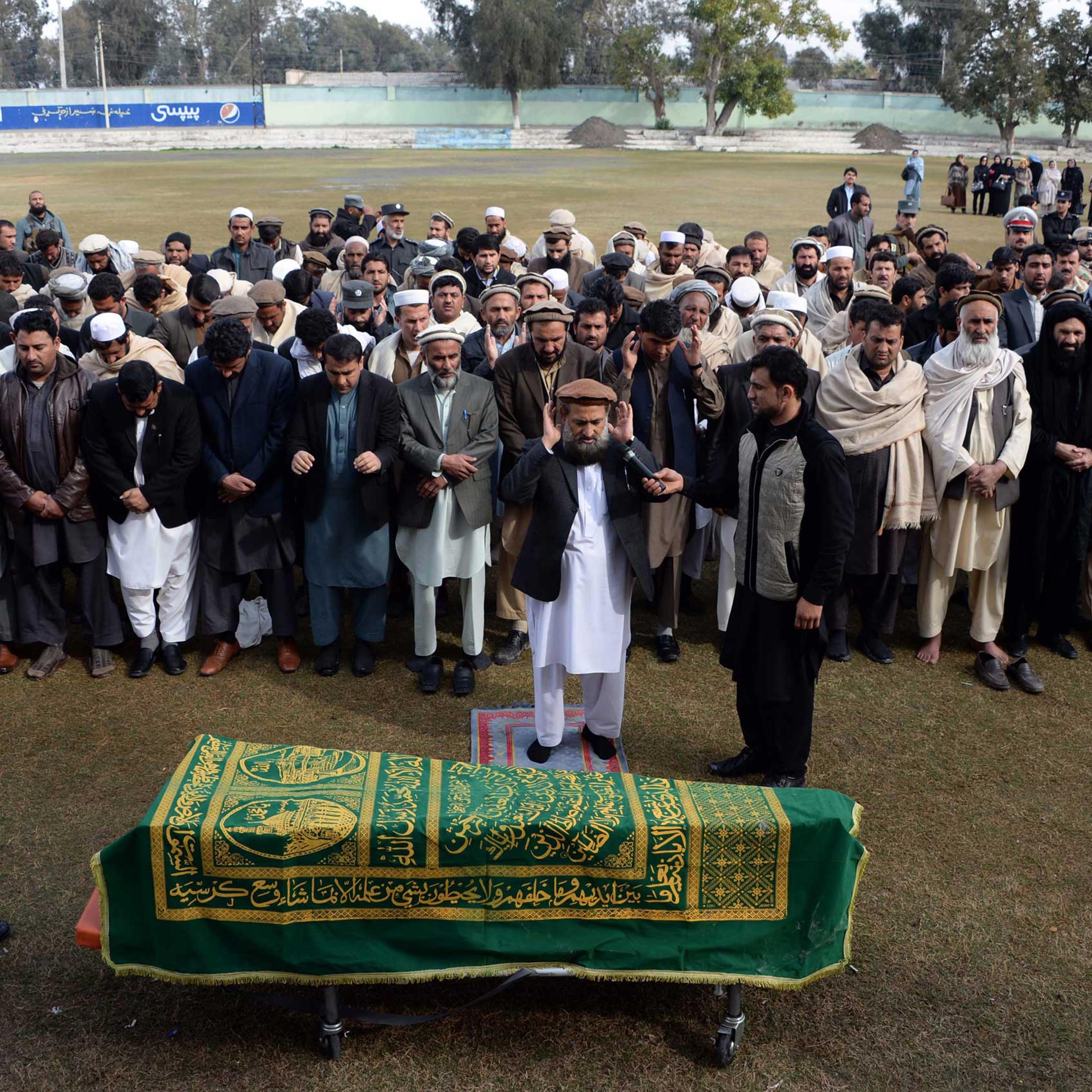 Afghan officials and mourners perform funeral prayers over the coffin of Angiza Shinwari, a provincial member, in Jalalabad on Feb. 16, 2015.