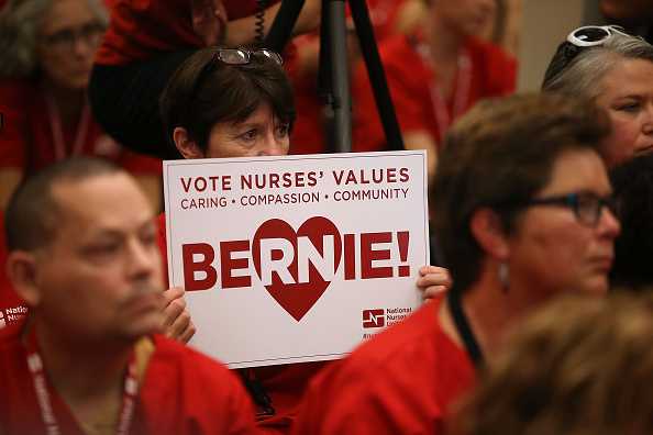 A nurse with the National Nurses United holds a campaign sign as Independent presidential candidate U.S. Sen. Bernie Sanders (I-VT) speaks during the "Brunch with Bernie" campaign rally at the National Nurses United offices on August 10, 2015 in Oakland,