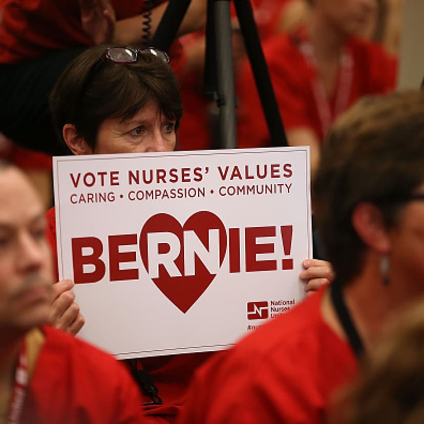 A nurse with the National Nurses United holds a campaign sign as Independent presidential candidate U.S. Sen. Bernie Sanders (I-VT) speaks during the "Brunch with Bernie" campaign rally at the National Nurses United offices on August 10, 2015 in Oakland,