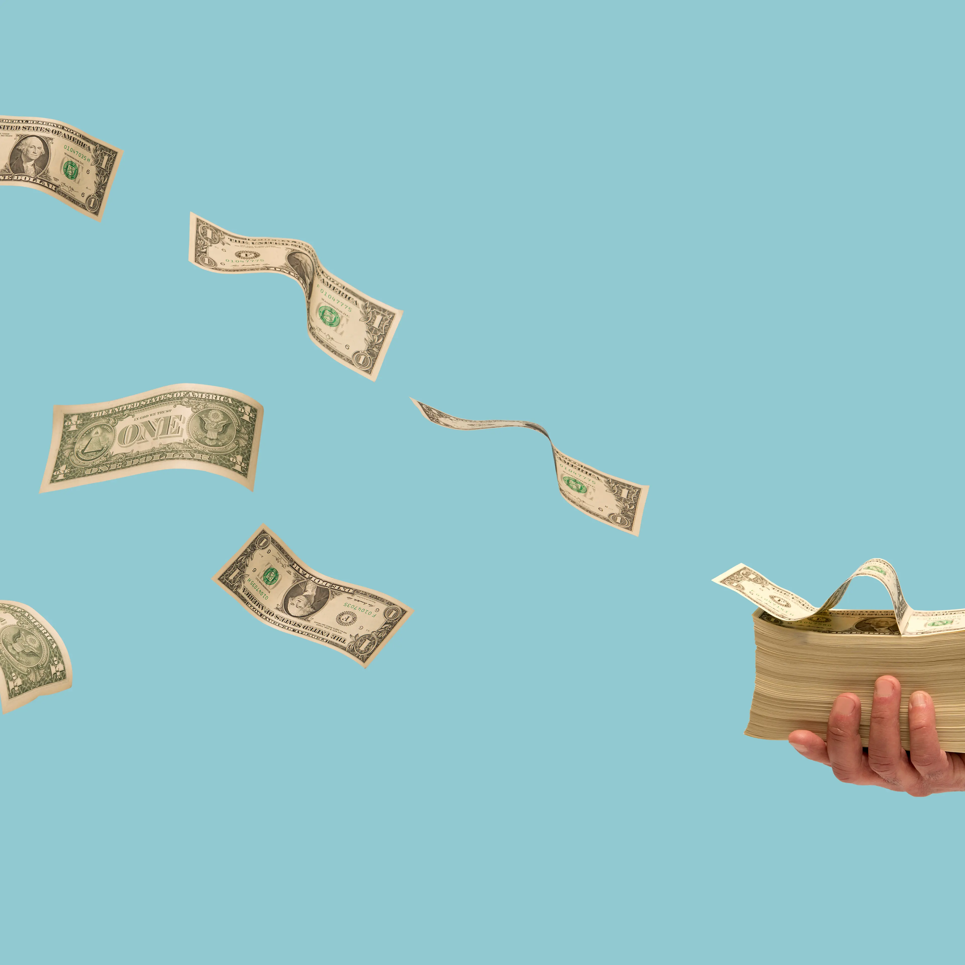 Money flying off stack of bills