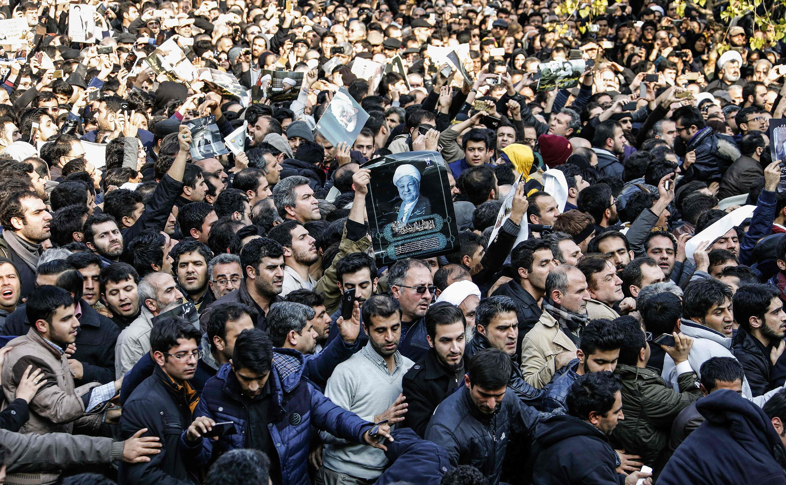 Iranians gather around a hearse carrying the coffin of former President Akbar Hashemi Rafsanjani during his funeral ceremony in Tehran on Jan. 10, 2017. The heavyweight politician will be buried inside the crypt of Ayatollah Ruhollah Khomeini, the leader