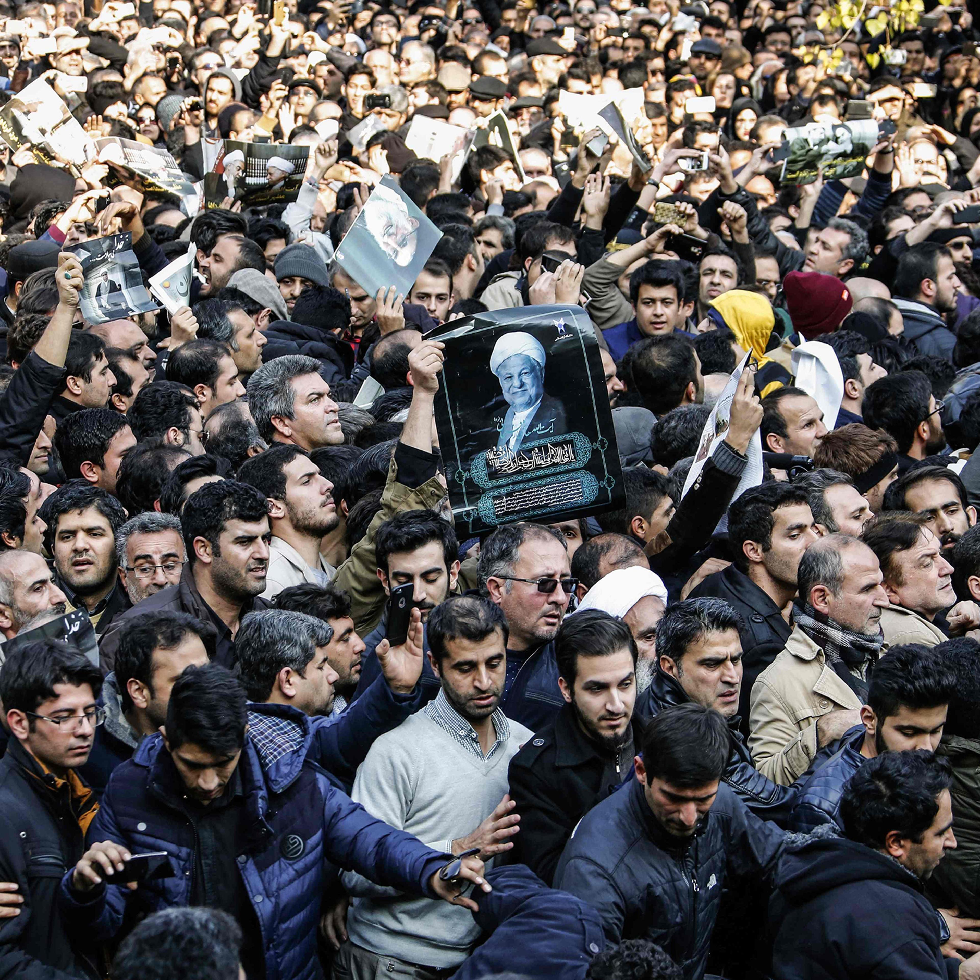 Iranians gather around a hearse carrying the coffin of former President Akbar Hashemi Rafsanjani during his funeral ceremony in Tehran on Jan. 10, 2017. The heavyweight politician will be buried inside the crypt of Ayatollah Ruhollah Khomeini, the leader