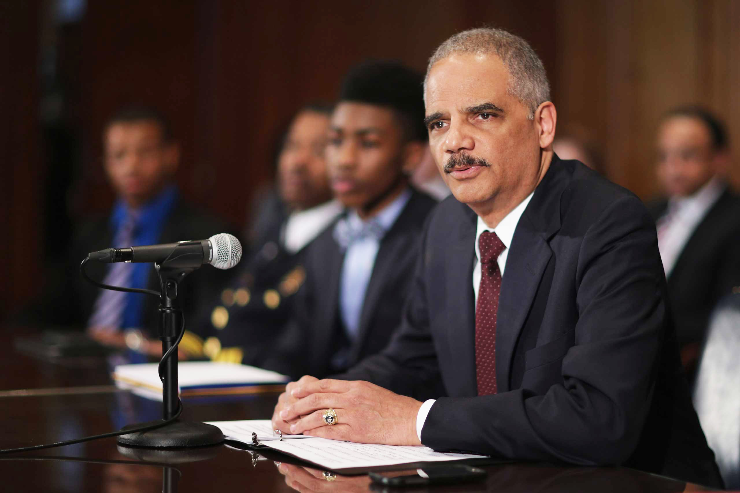 U.S. Attorney General Eric Holder delivers remarks about the shooting of two police officers in Ferguson, Missouri, while announcing the first six pilot sites for the National Initiative for Building Community Trust and Justice at the Department of Justi