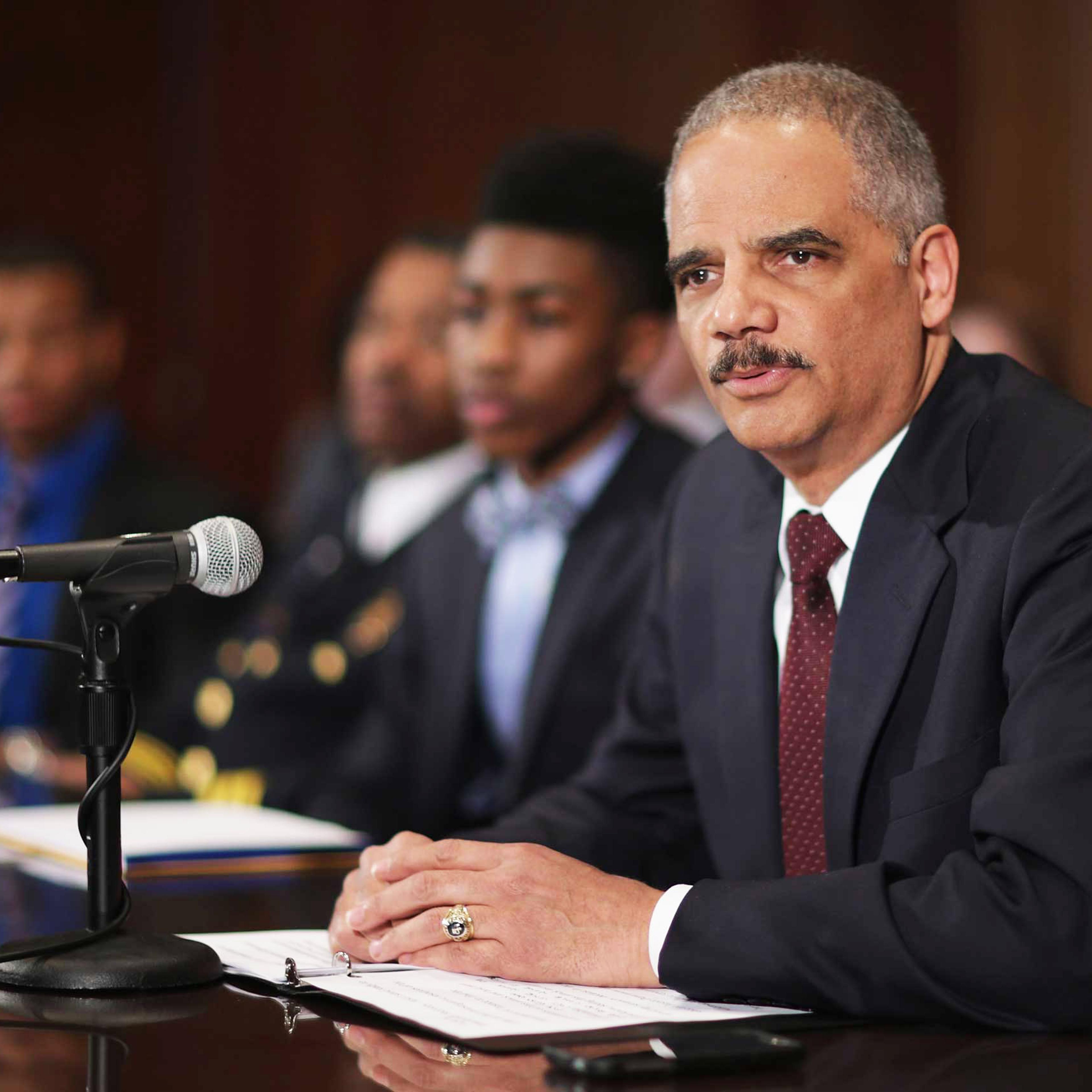 U.S. Attorney General Eric Holder delivers remarks about the shooting of two police officers in Ferguson, Missouri, while announcing the first six pilot sites for the National Initiative for Building Community Trust and Justice at the Department of Justi