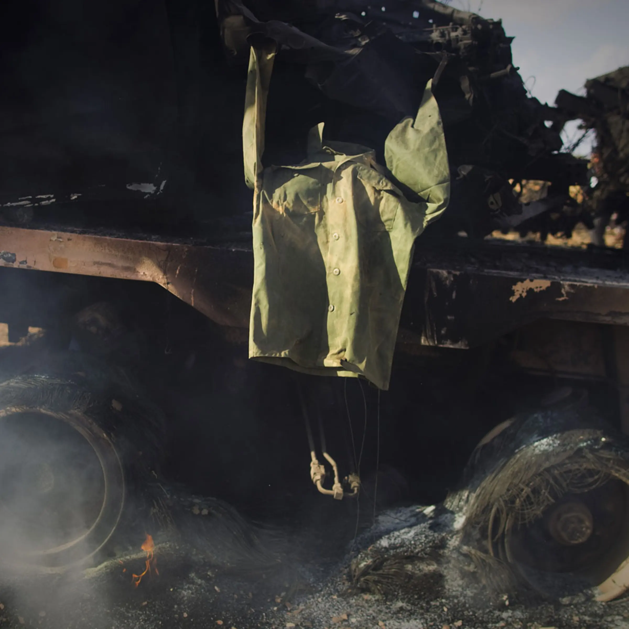 A soldier's jacket belonging to forces of Muammar Gaddafi is displayed on a burning tank on the outskirts of Benghazi, Libya, on <br>March 20, 2011