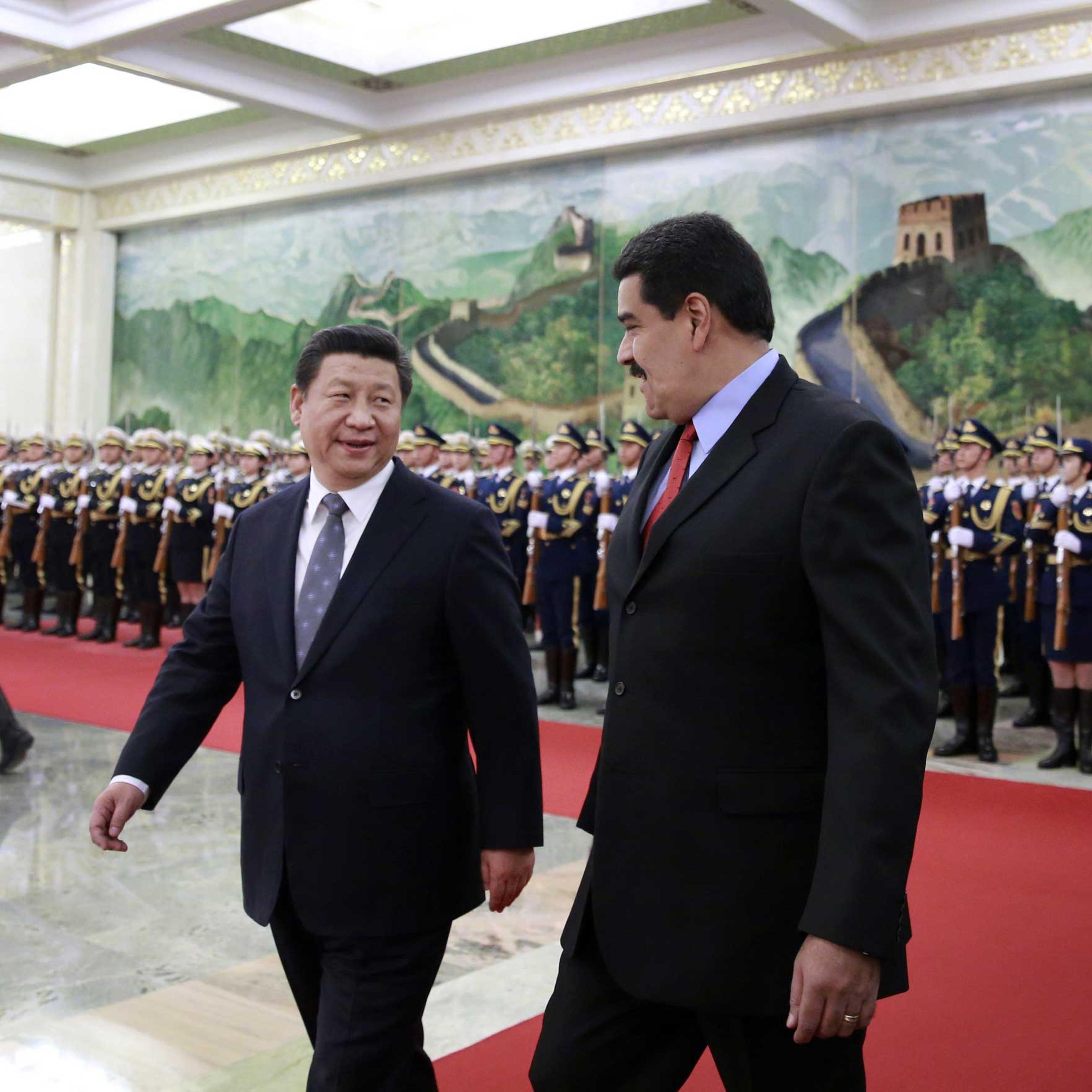 Venezuela's President Nicolas Maduro and Chinese President Xi Jinping chat after reviewing an honor guard during a welcome ceremony at the Great Hall of the People in Beijing on Jan. 7, 2015.