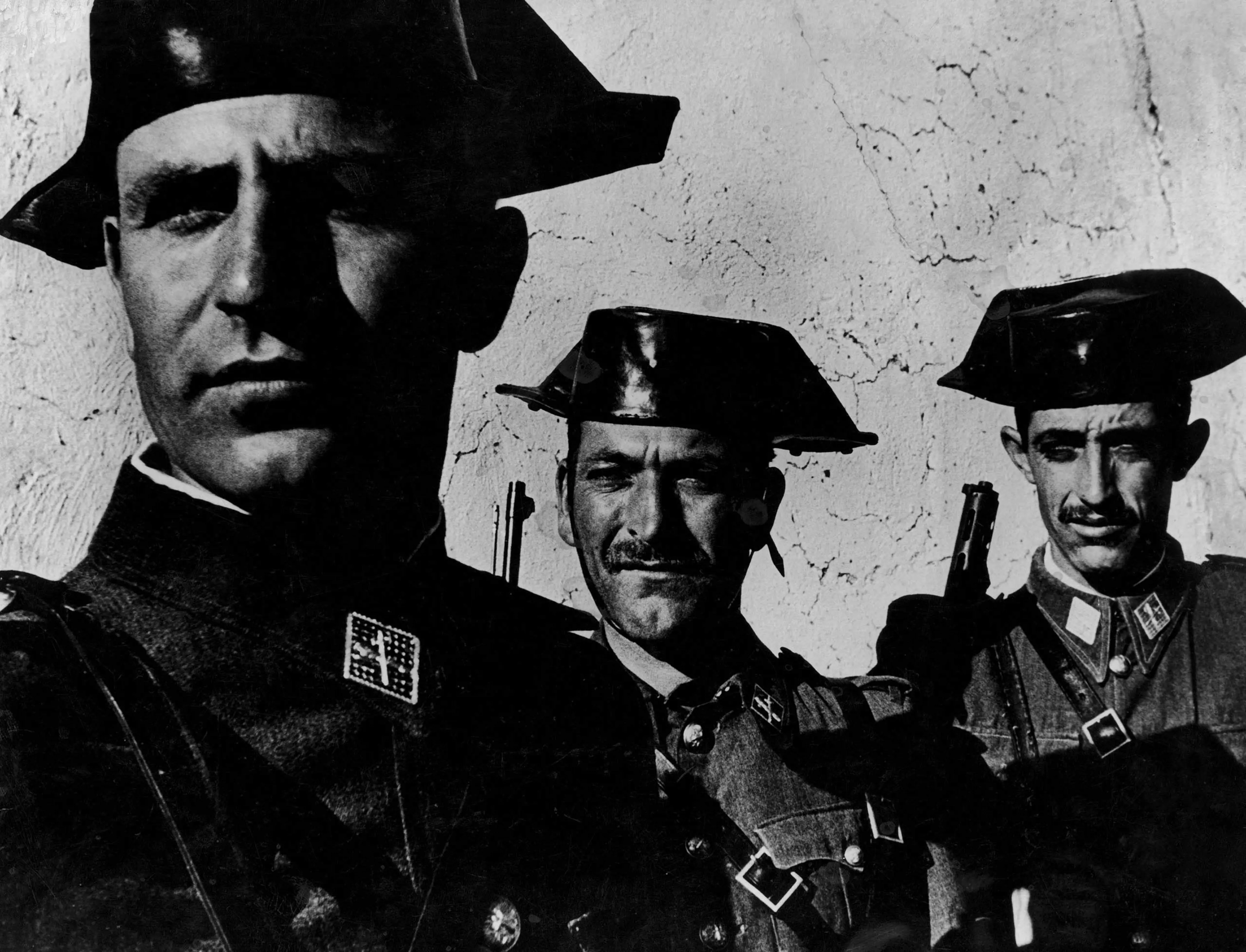 In the single most famous image from W. Eugene Smith's magisterial photo essay, "Spanish Village," the faces of three members of dictator Francisco Franco's feared Guardia Civil evince the arrogance often assumed by small men granted great power over oth