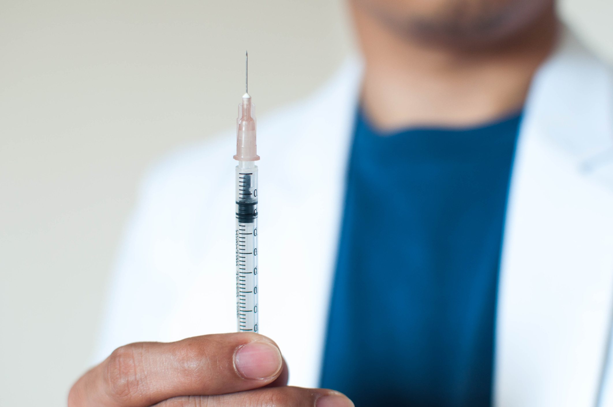A doctor holding a flu shot