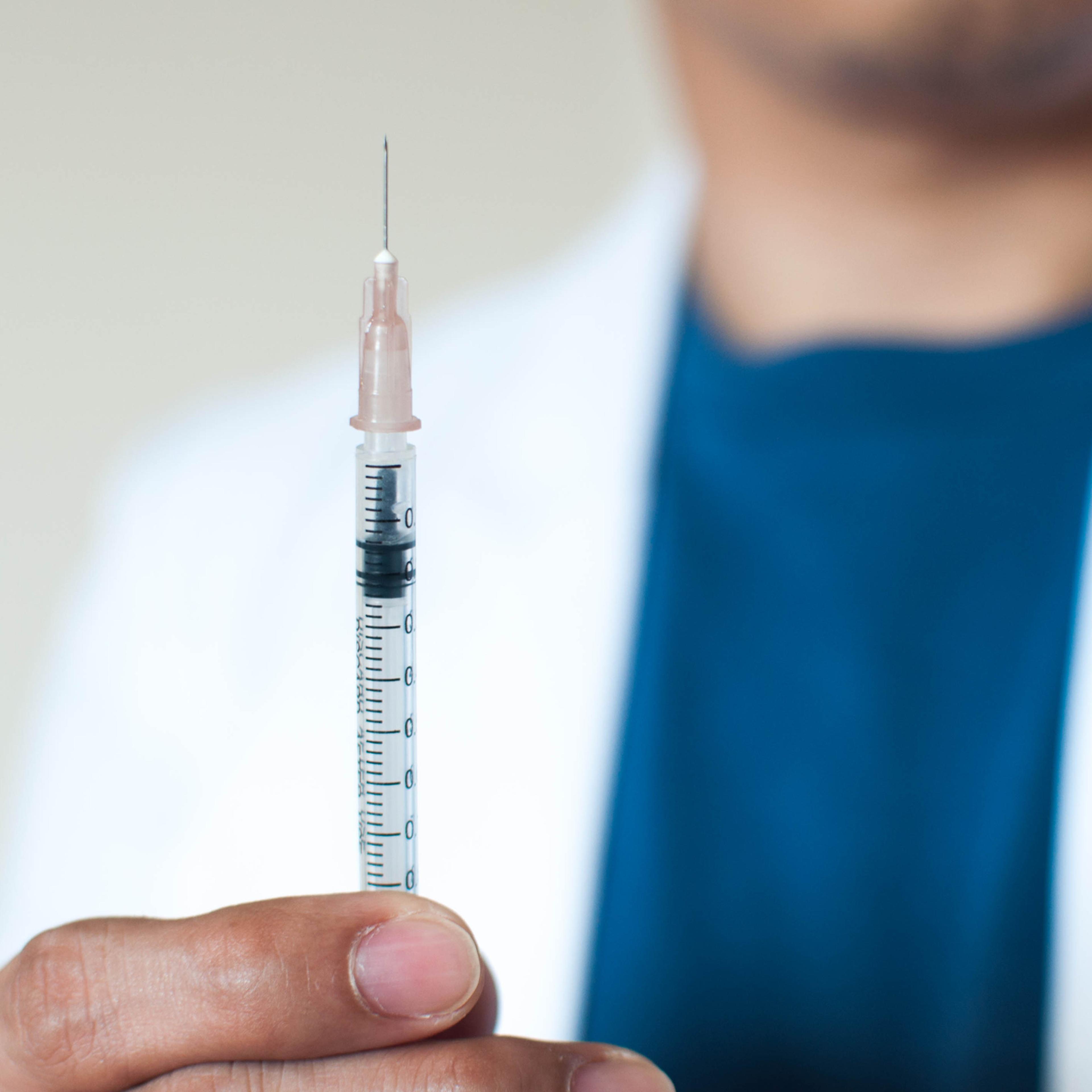 A doctor holding a flu shot