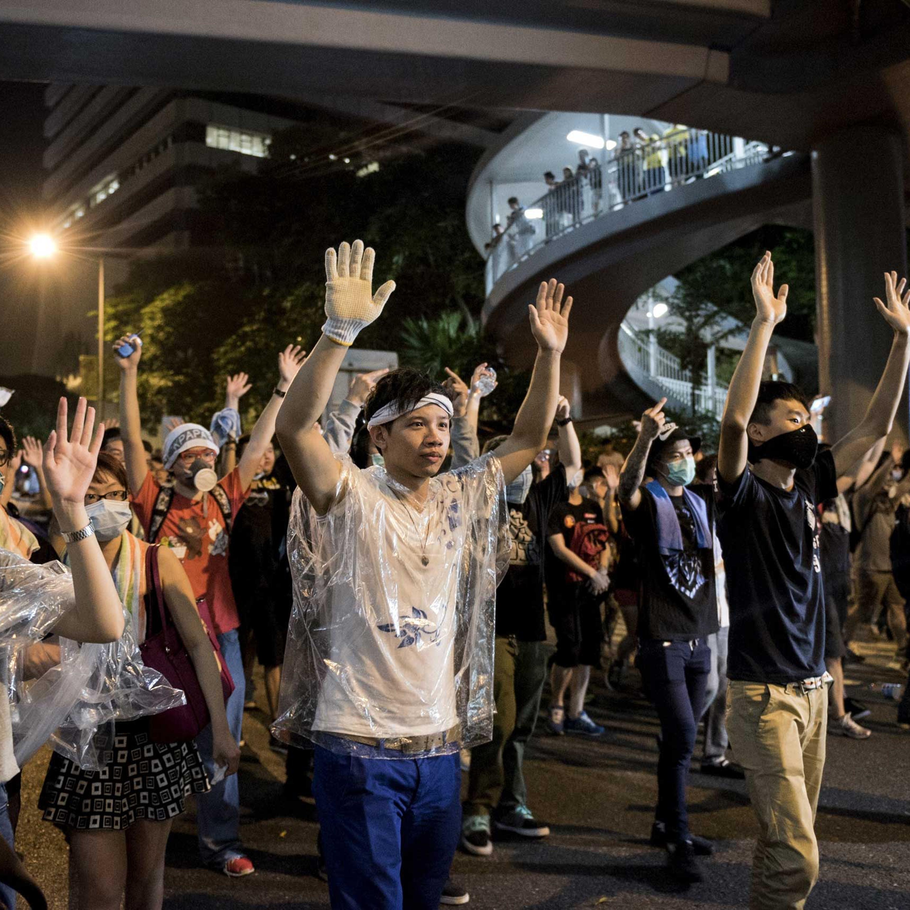 Pro-democracy protesters put their hands up in the air in front of the police in Hong Kong on Sept. 28, 2014.