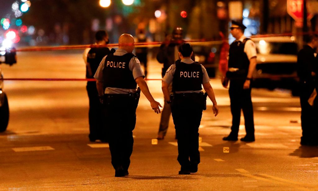Chicago Police officers investigate the scene of a shooting in Chicago, Illinois, on July 21, 2020.